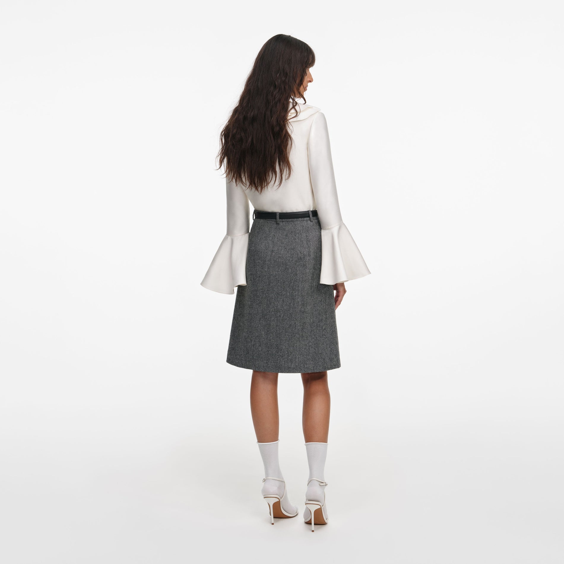 Back view of a woman wearing the Cream Taffeta Ruffle Top