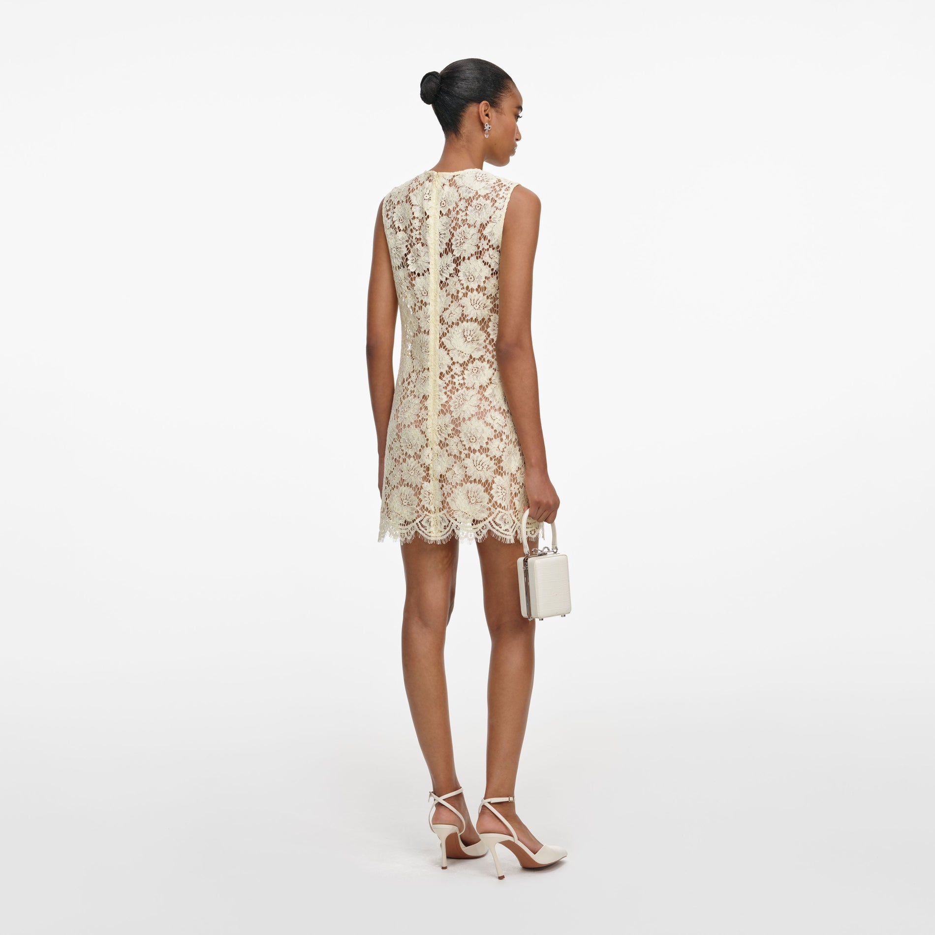 Back view of a woman wearing the Yellow Fine Lace Mini Dress