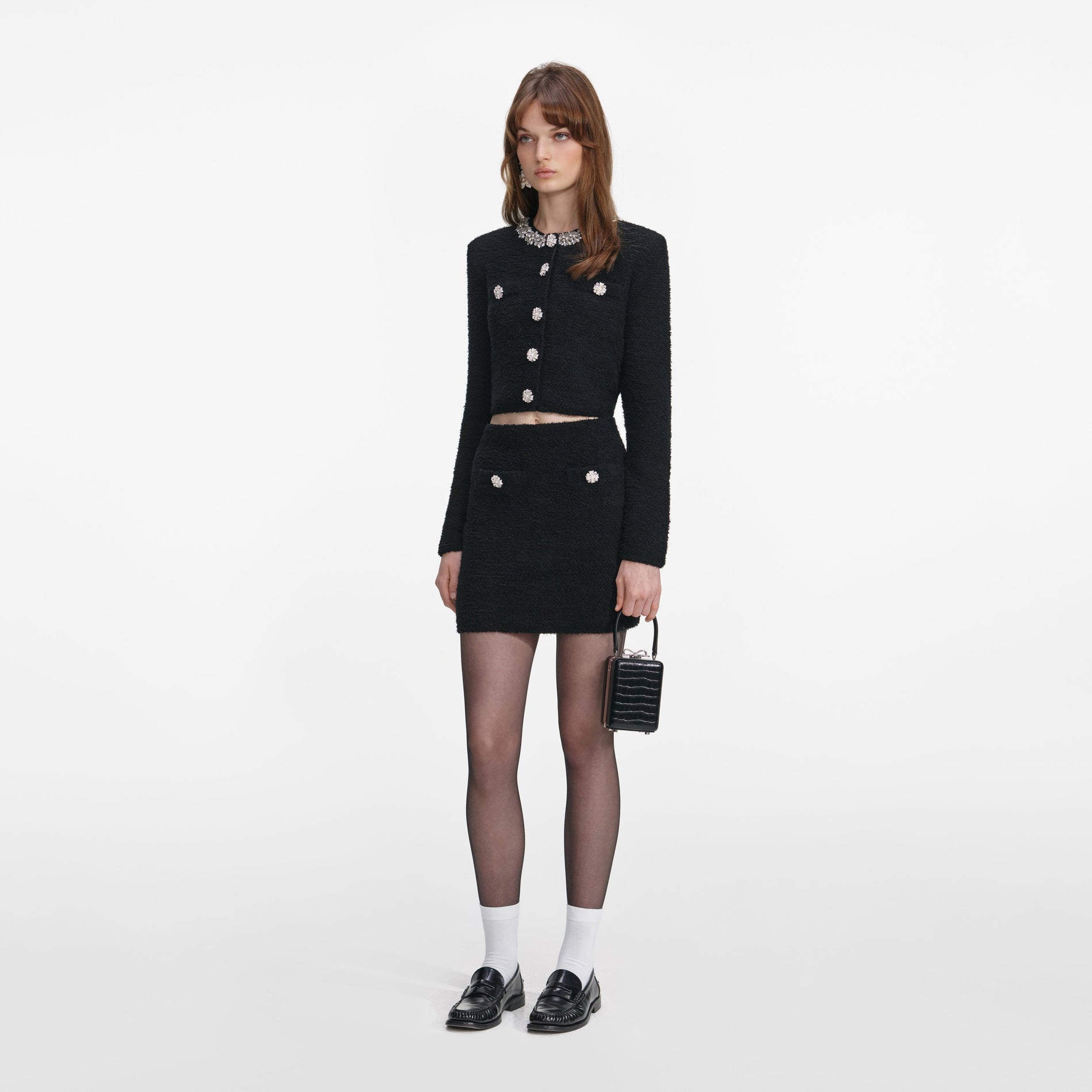 Side view of a woman wearing the Black Crystal Trim Cardigan