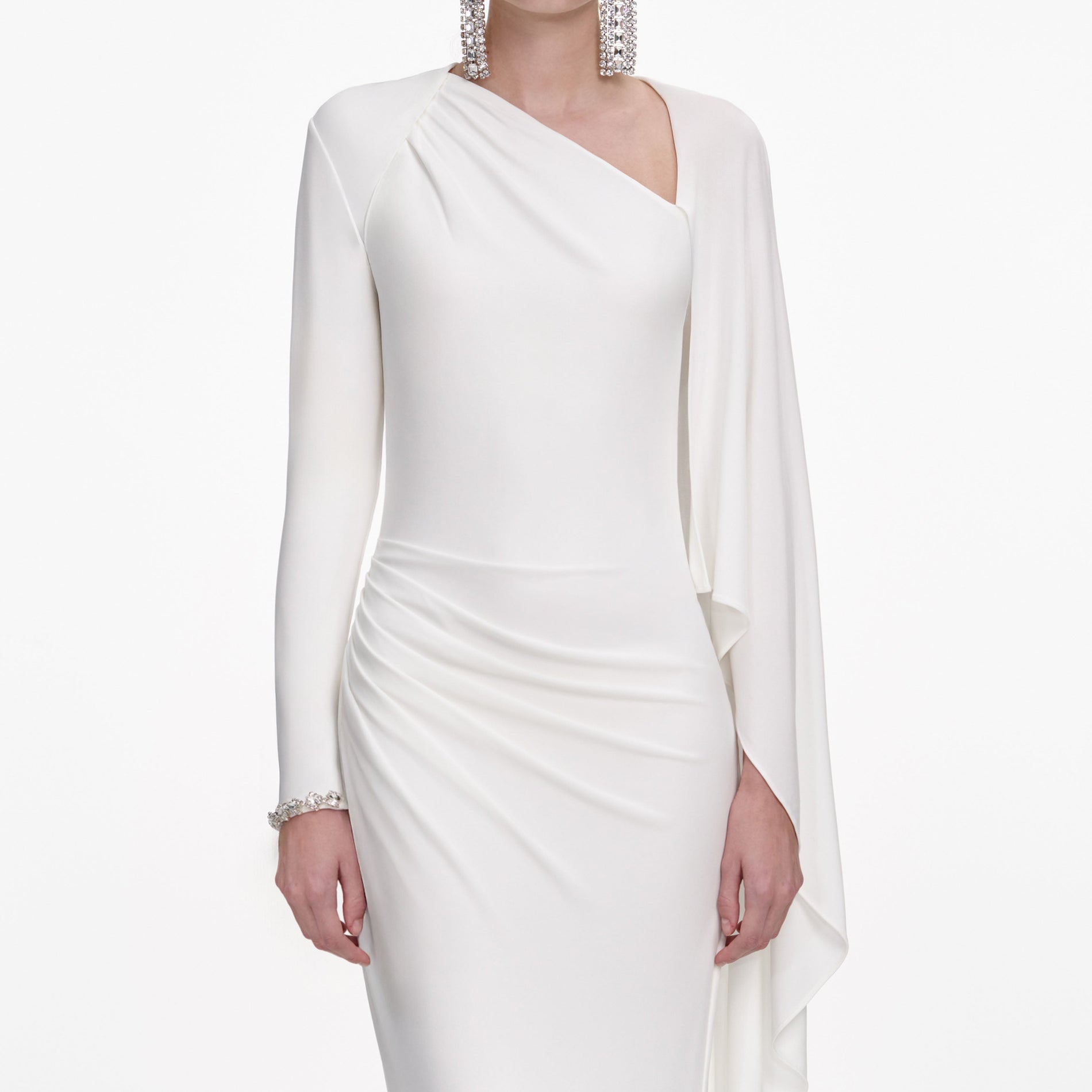 A close up of a woman wearing the White Jersey Drape Maxi Dress