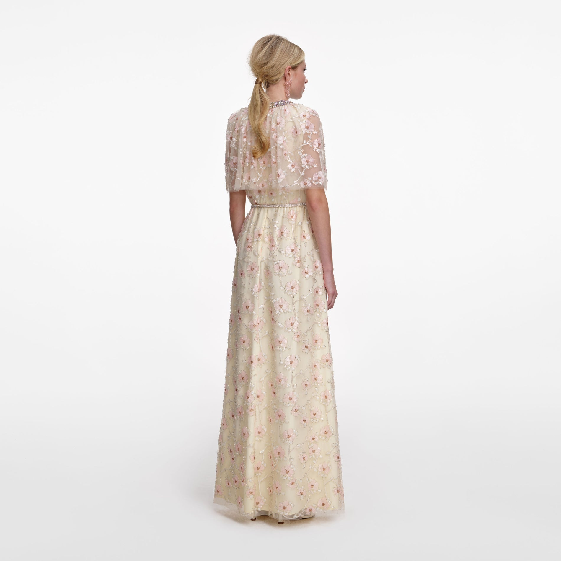 Back view of a woman wearing the Champagne Floral Embellished Maxi Dress
