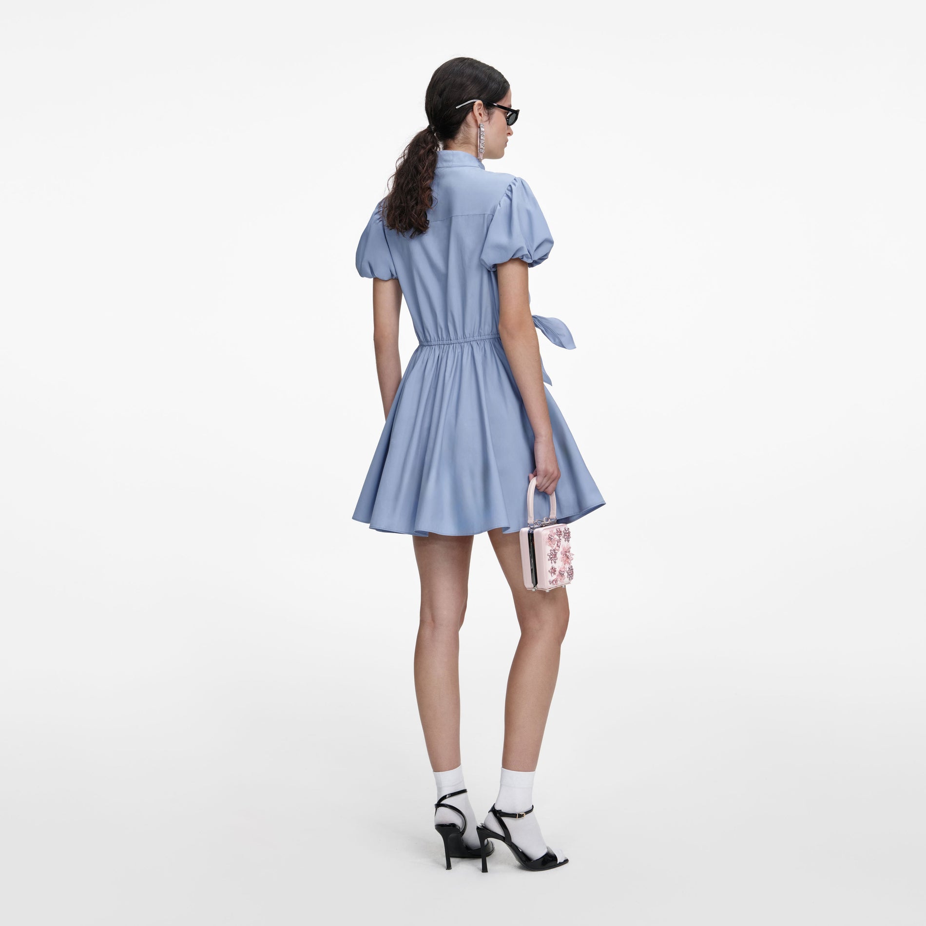 Back view of a woman wearing the Blue Cotton Drape Mini Dress