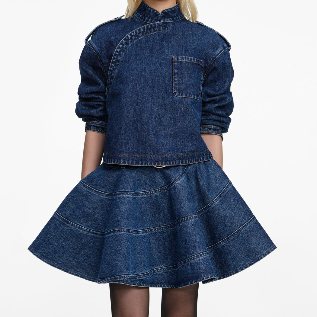 A close up of a woman wearing the Flared Denim Mini Skirt