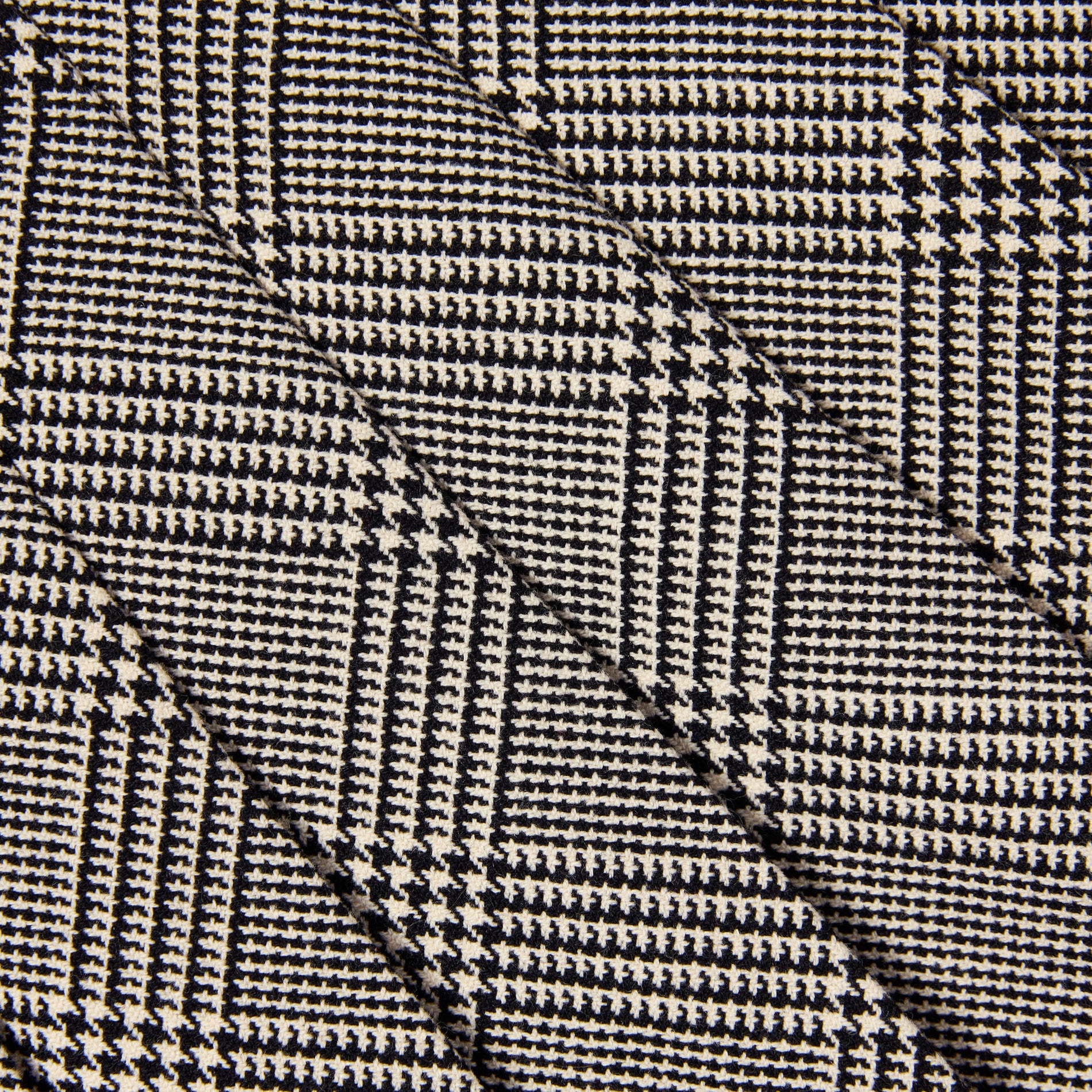 Black and white houndstooth fabric with diagonal folds