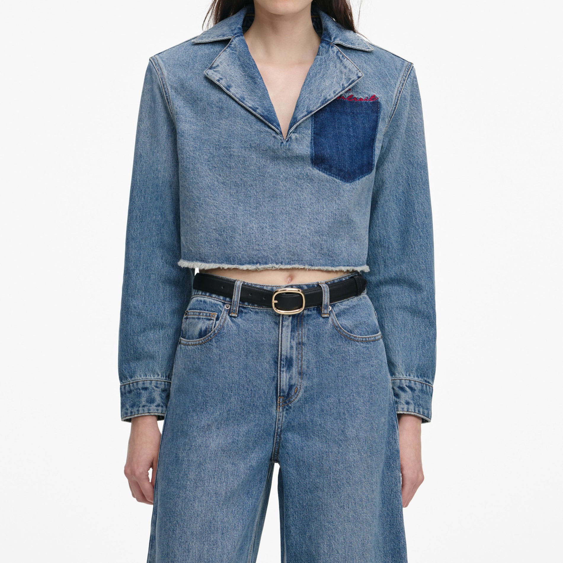 A close up of a woman wearing the Cropped Denim Shirt