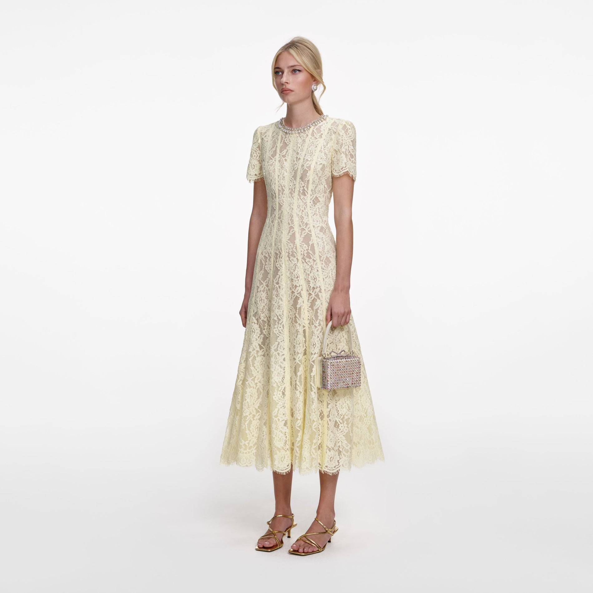 Side view of a woman wearing the Yellow Lace Embellished Midi Dress