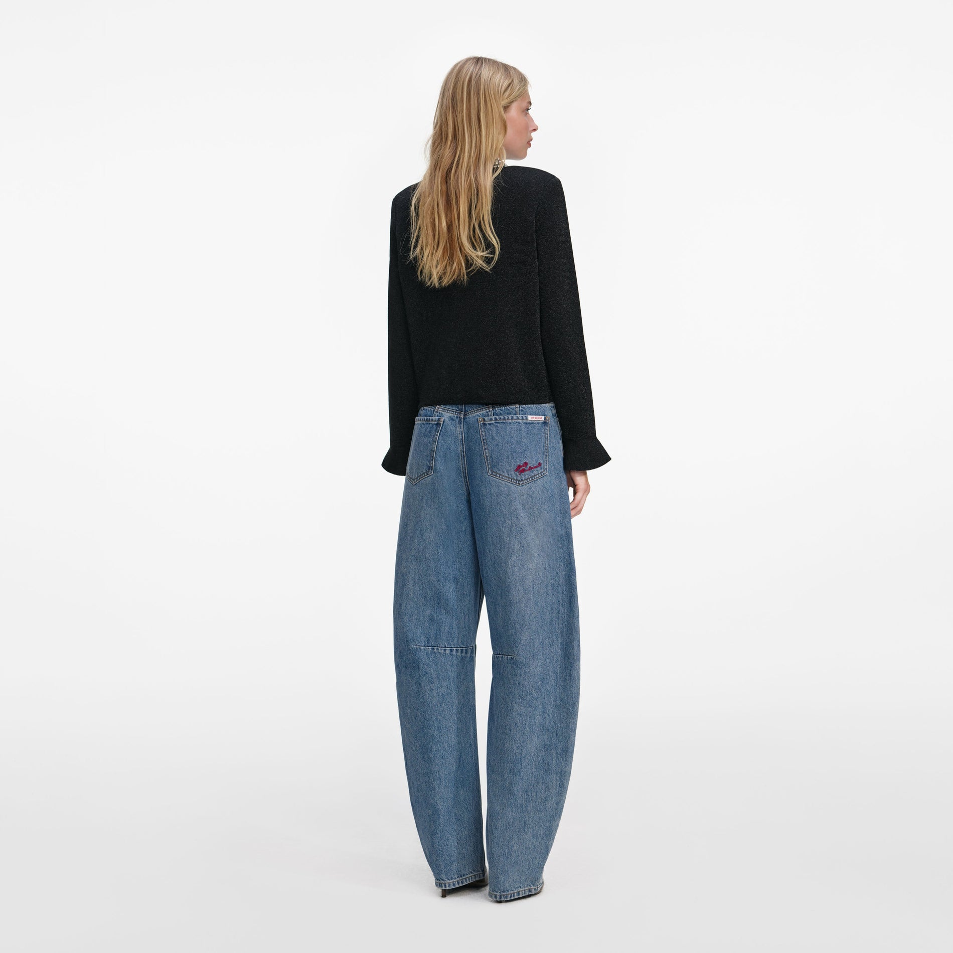 Back view of a woman wearing the Black Crystal Button Cardigan