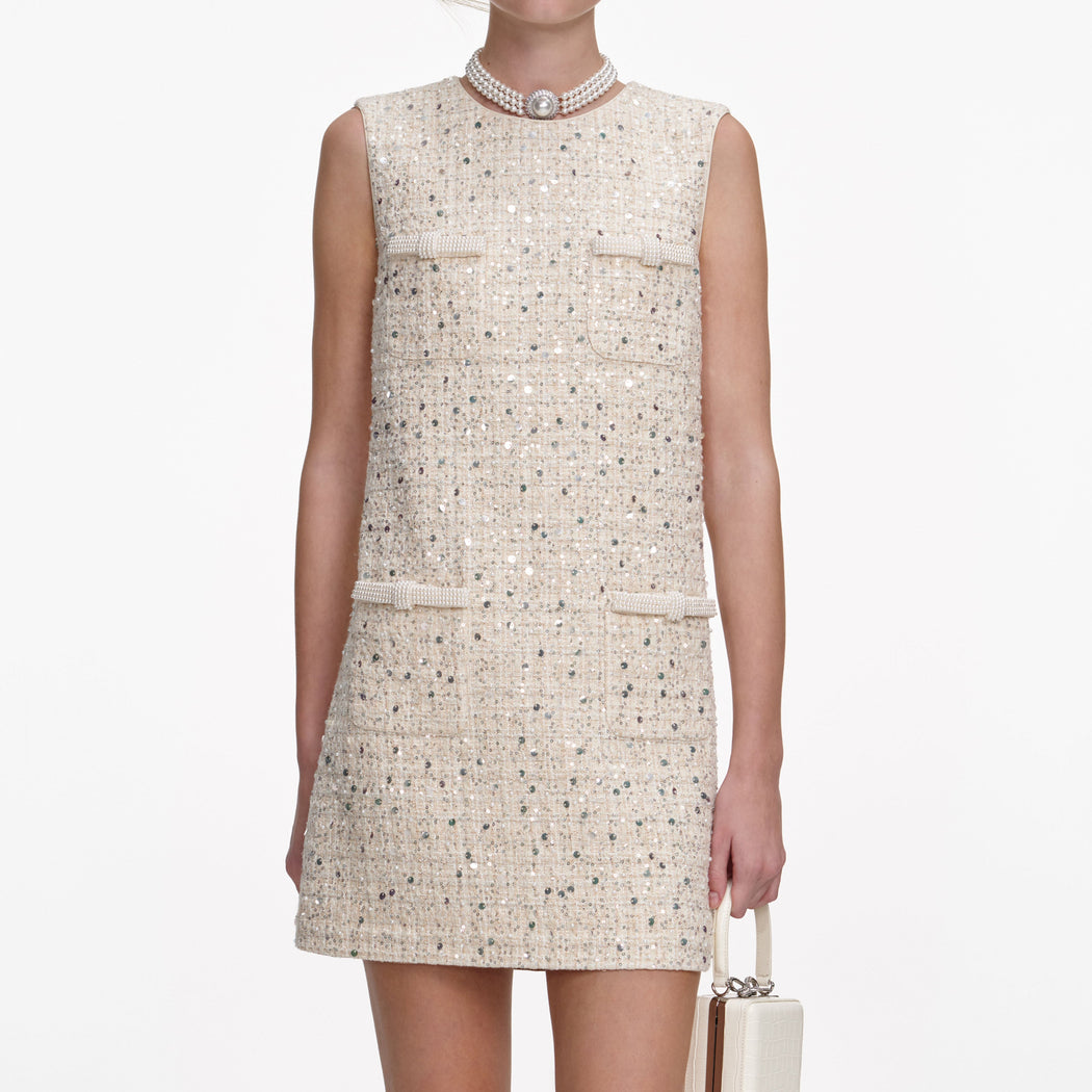 A close up of a woman wearing the Cream Embellished Boucle Mini Dress