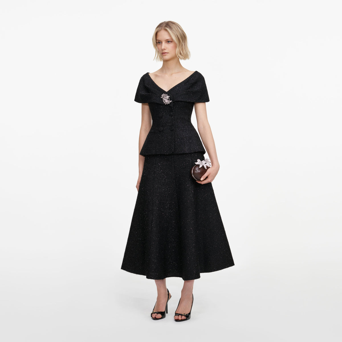 Side view of a woman wearing the Black Tinsel Boucle Brooch Midi Dress