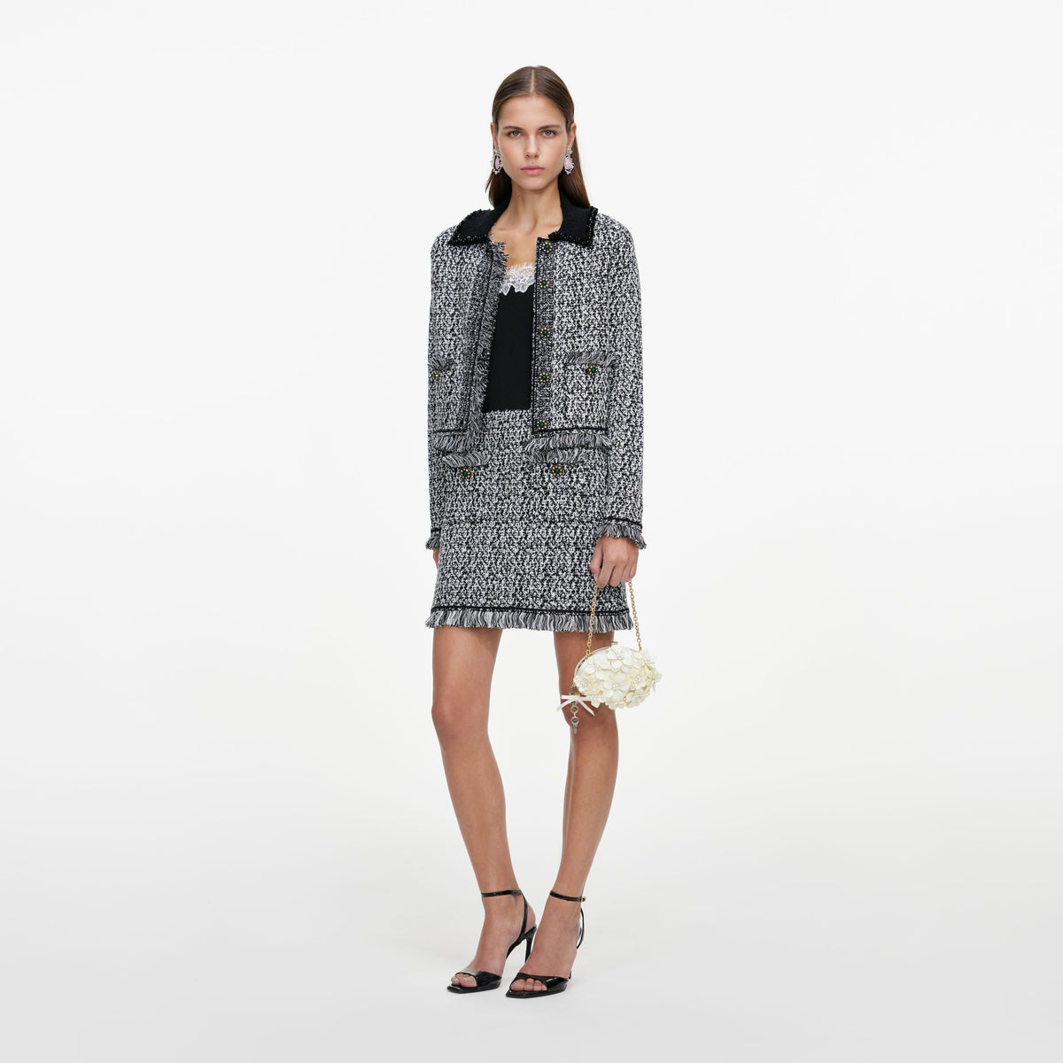 Side view of a woman wearing the Black And White Textured Knit Jacket