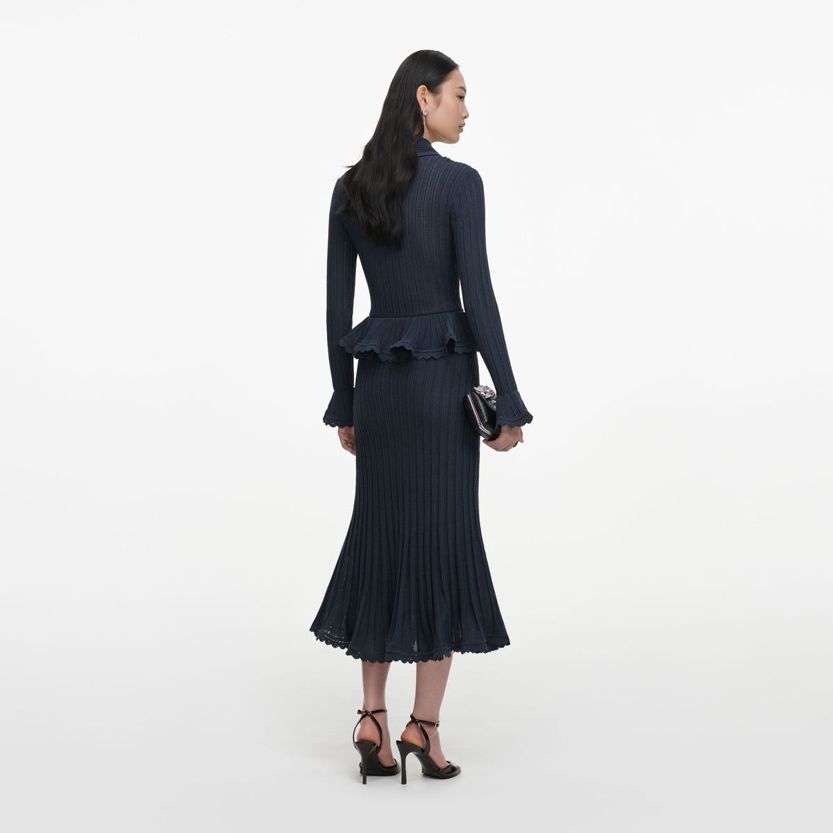 Back view of a woman wearing the Grey Peplum Pointelle Knit Midi Dress