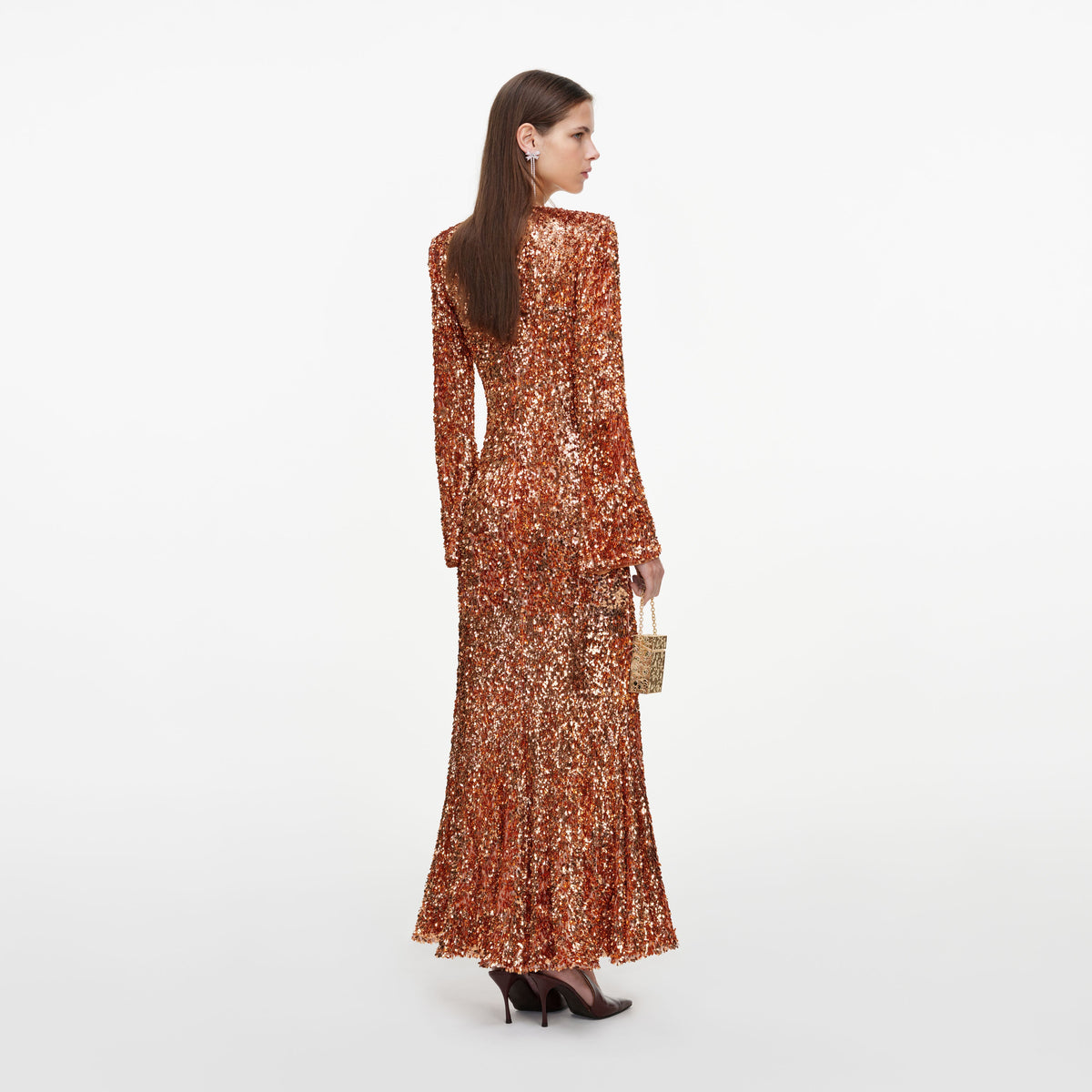Back view of a woman wearing the Gold Sequin Maxi Dress