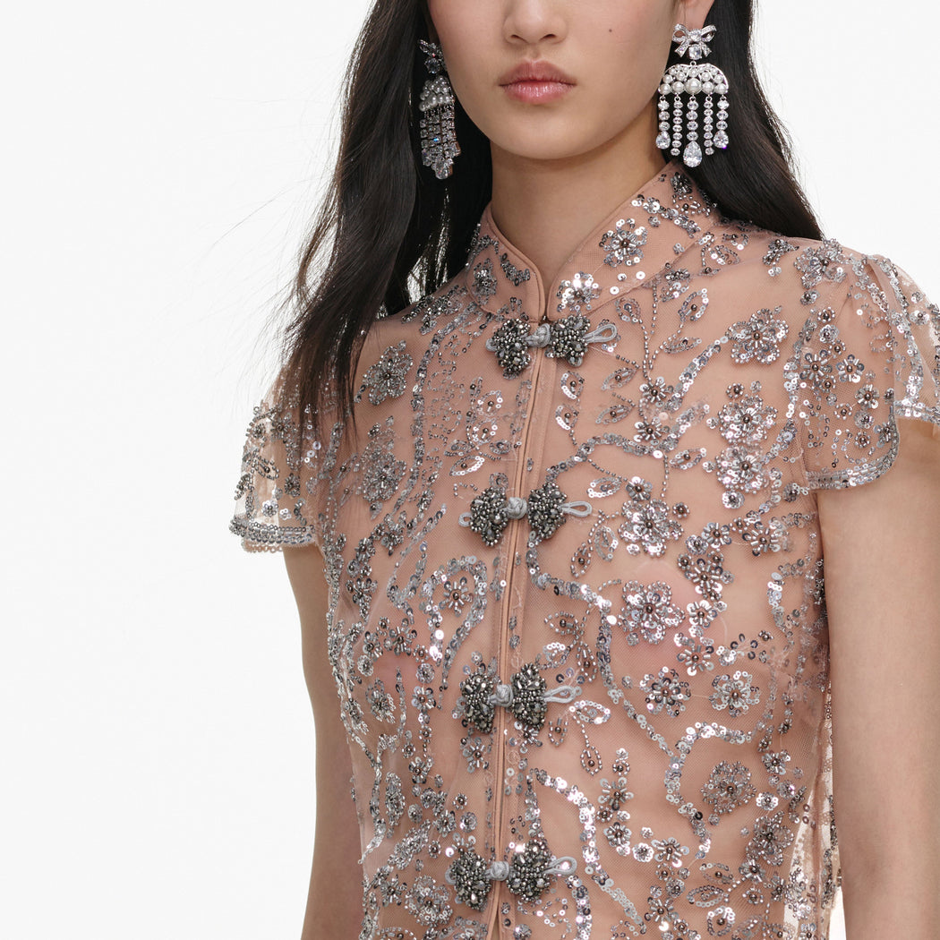 A close up of the fabric for the Silver Sequin Embellished Top