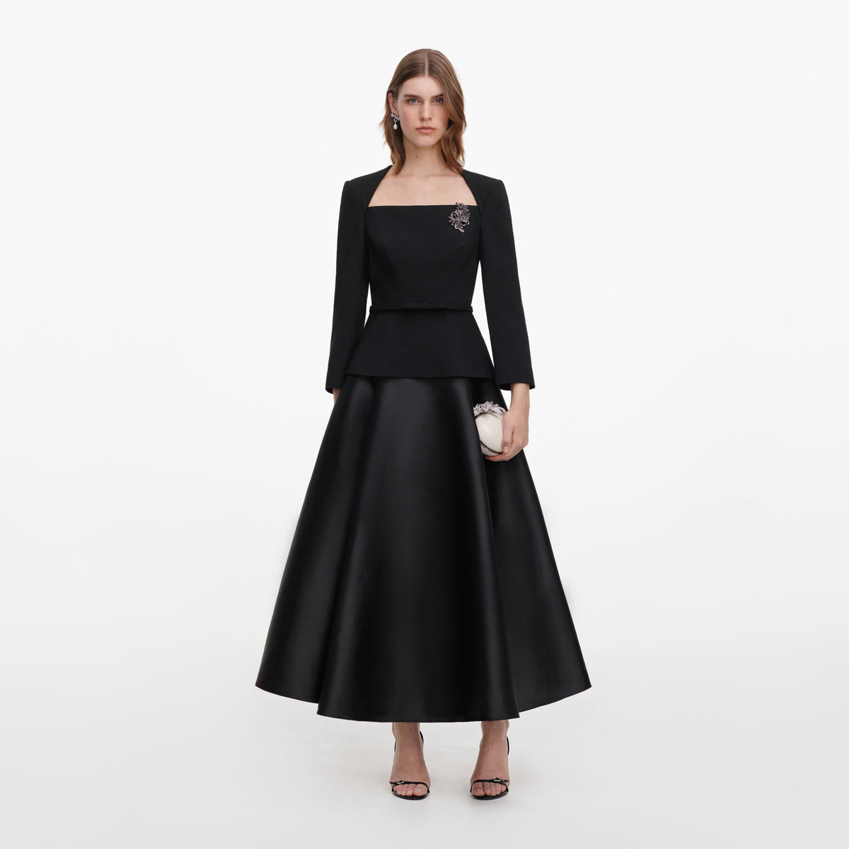 Front view of a woman wearing the Black Taffeta Brooch Midi Dress