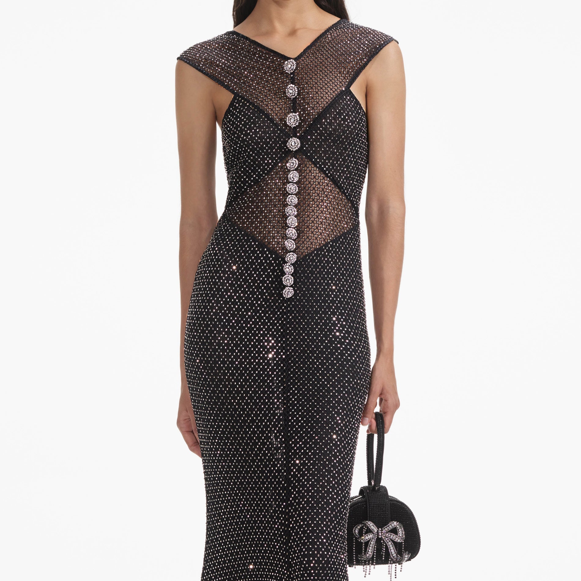 A close up of a woman wearing the Black Rhinestone Fishnet Crossover Midi Dress
