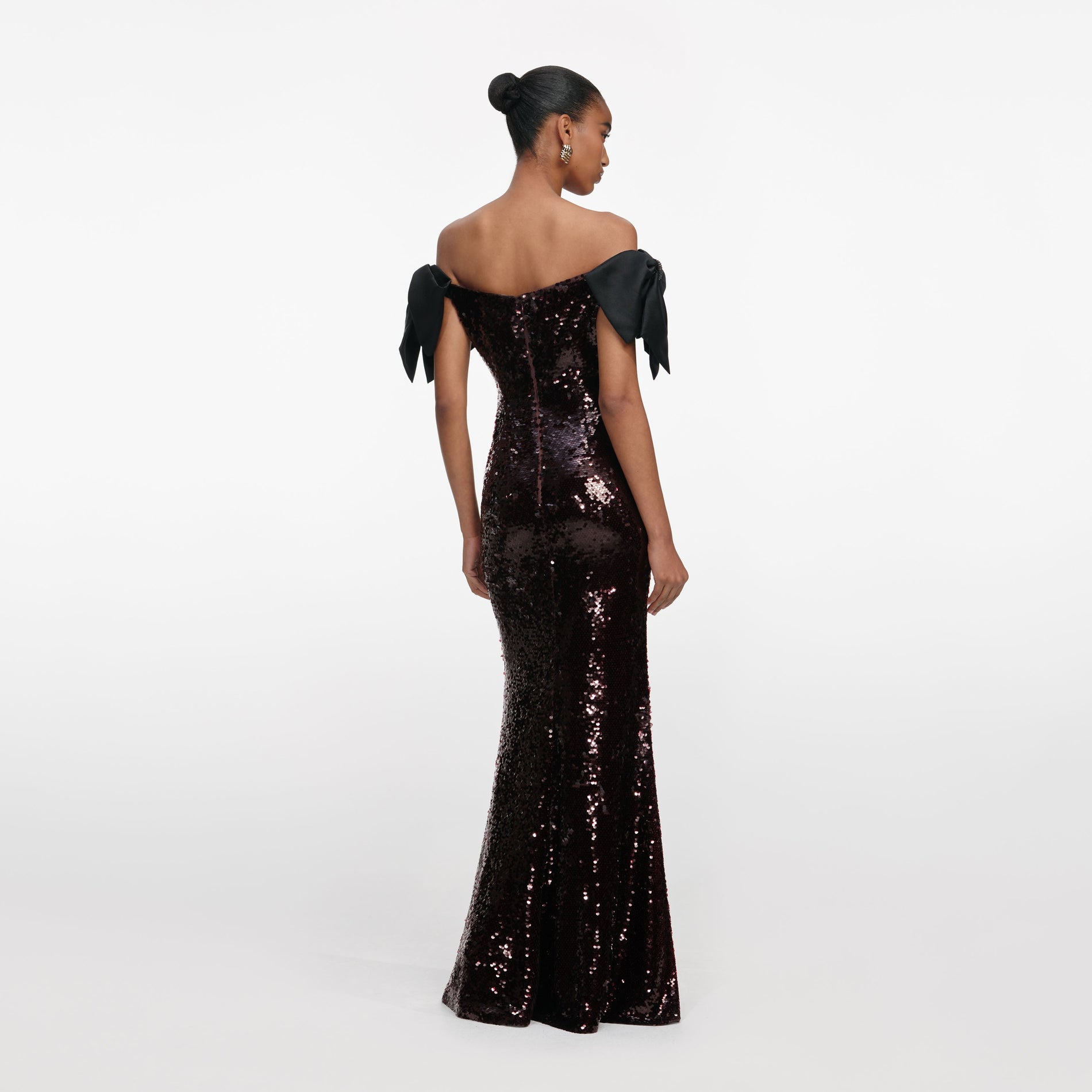 Back view of a woman wearing the Brown Sequin Bow Maxi Dress