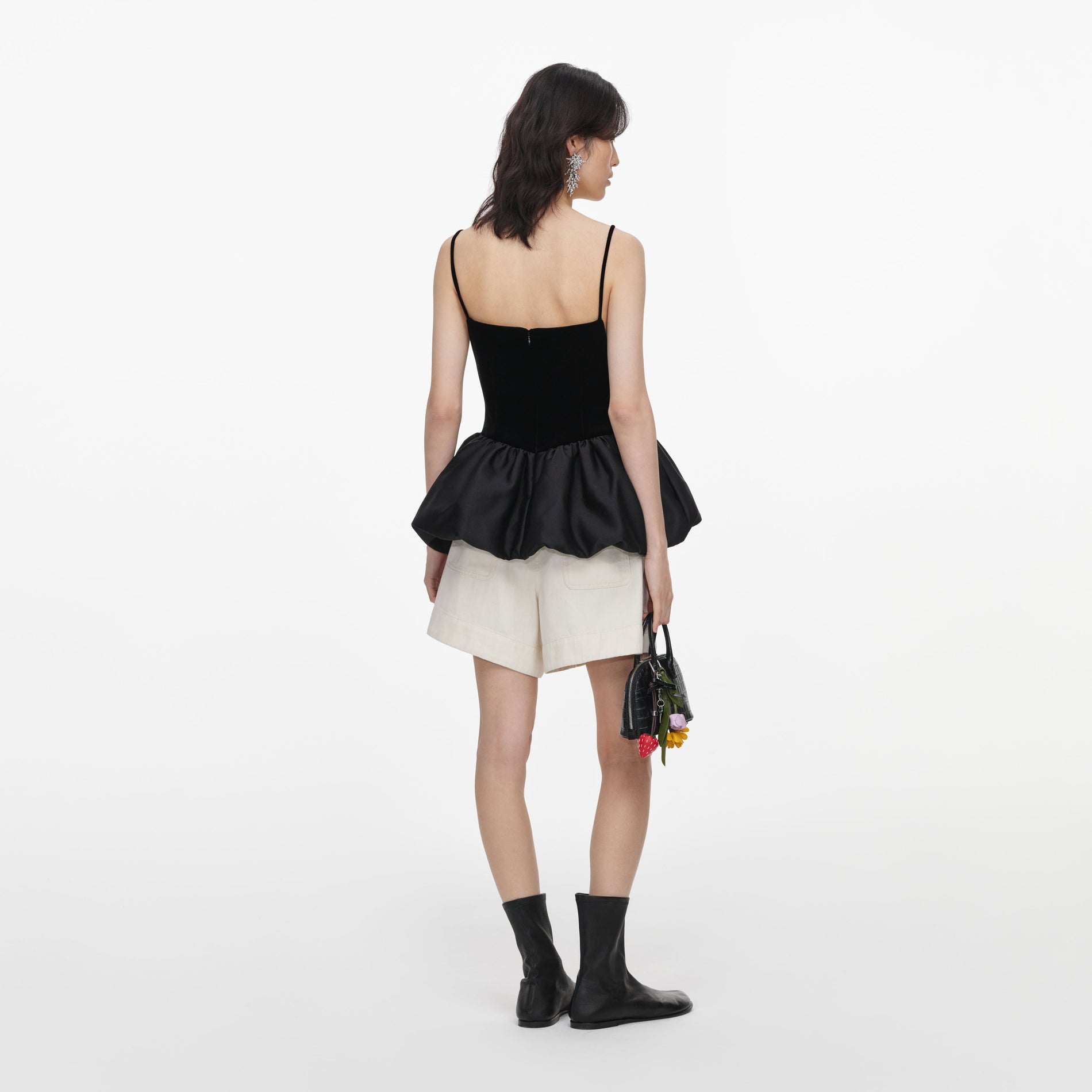 Back view of a woman wearing the Black Velvet Bubble Hem Top