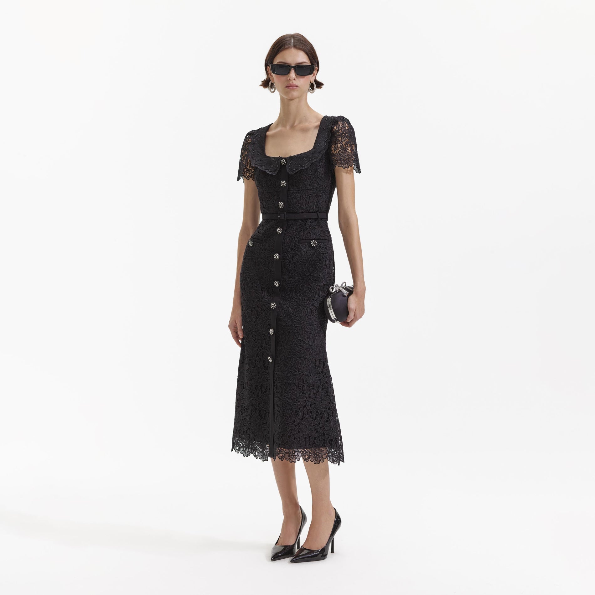 Side view of a woman wearing the Black Guipure Lace Button Midi Dress