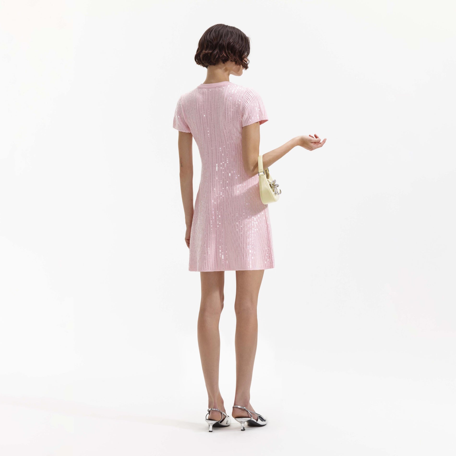Back view of a woman wearing the Pink Sequin Knit Mini Dress