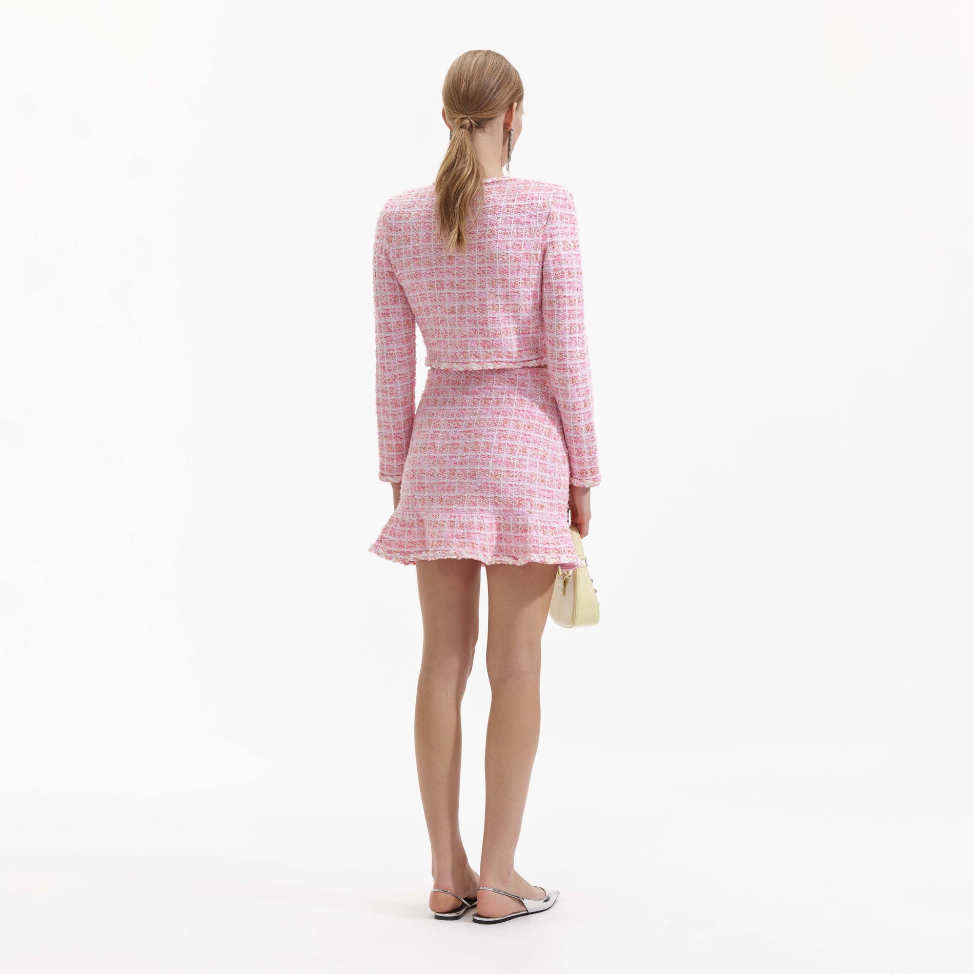 Back view of a woman wearing the Pink Check Knit Skirt