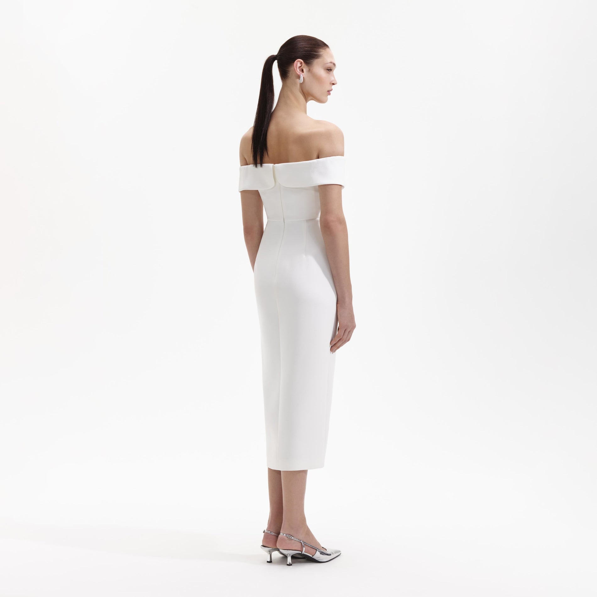 Back view of a woman wearing the White Crepe Bow Midi Dress