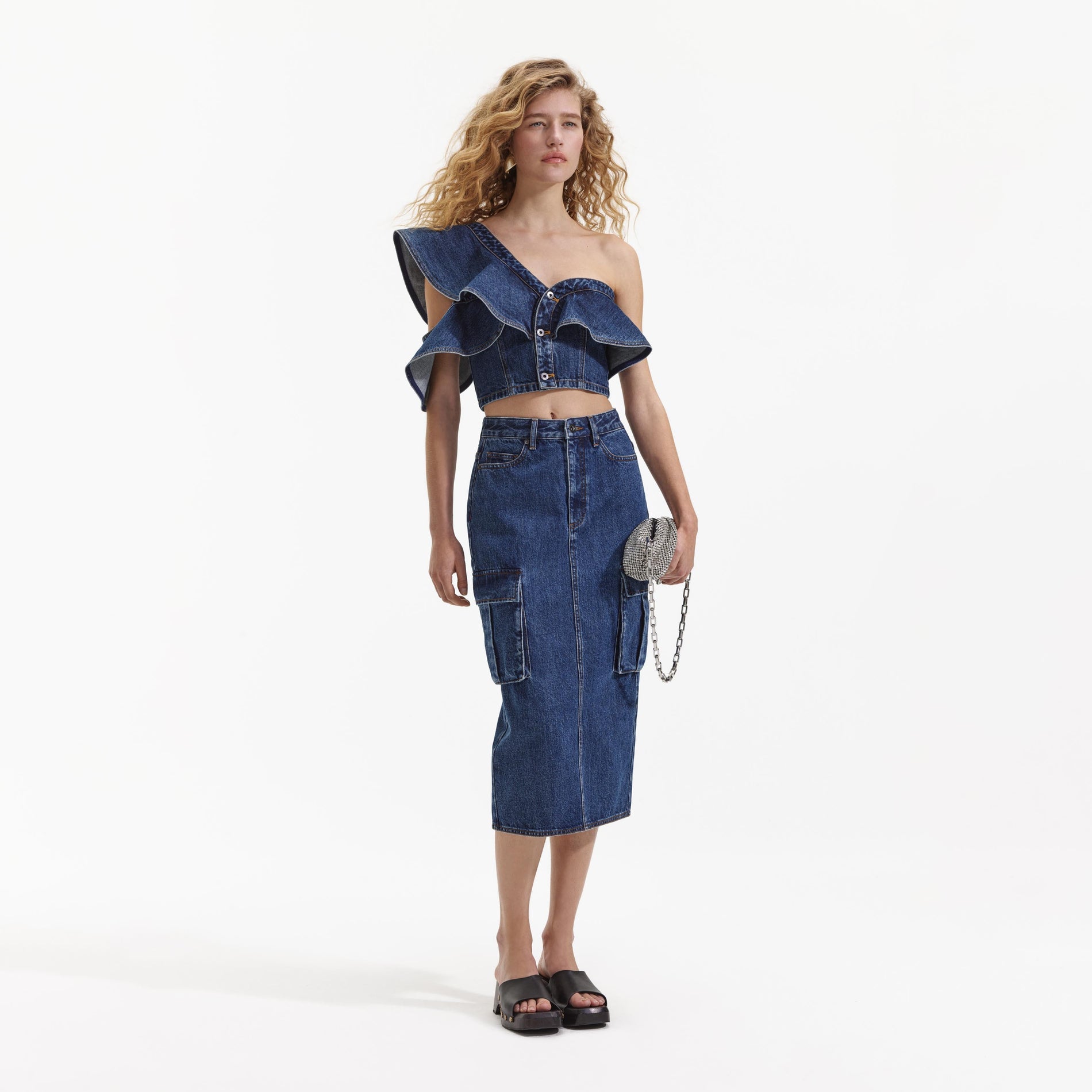 Back view of a woman wearing the Denim Cargo Midi Skirt