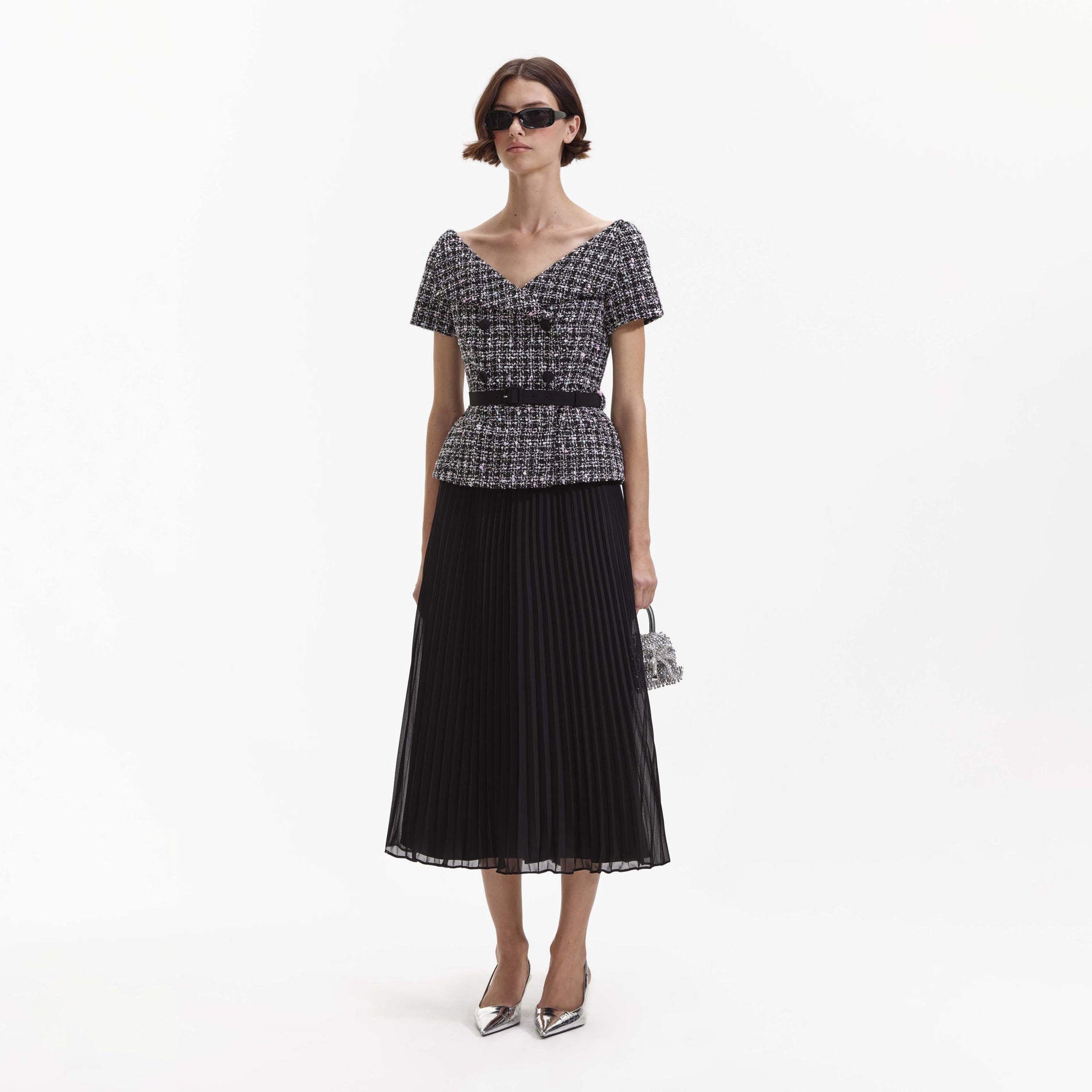 Side view of a woman wearing the Black Boucle Off Shoulder Midi Dress