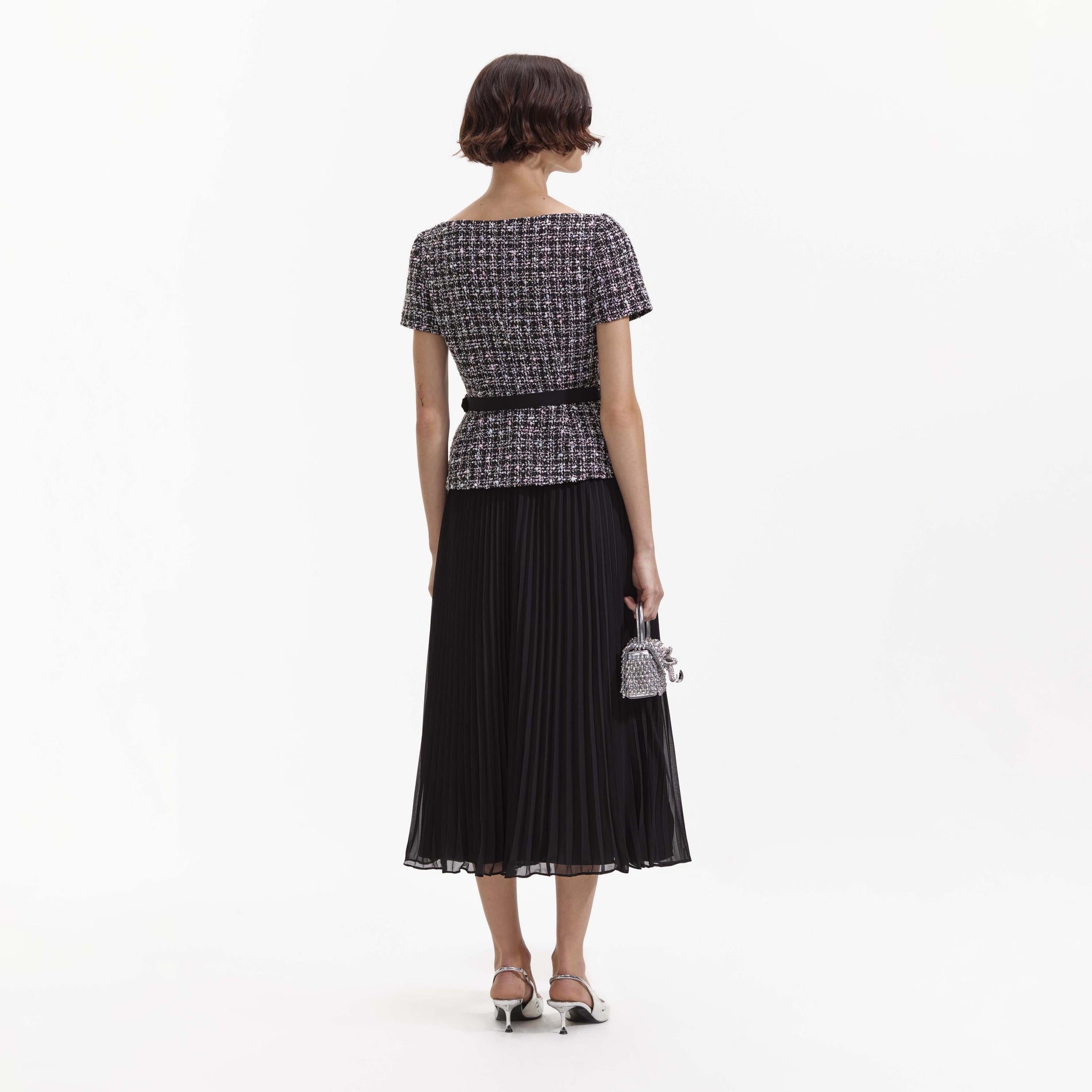 Back view of a woman wearing the Black Boucle Off Shoulder Midi Dress
