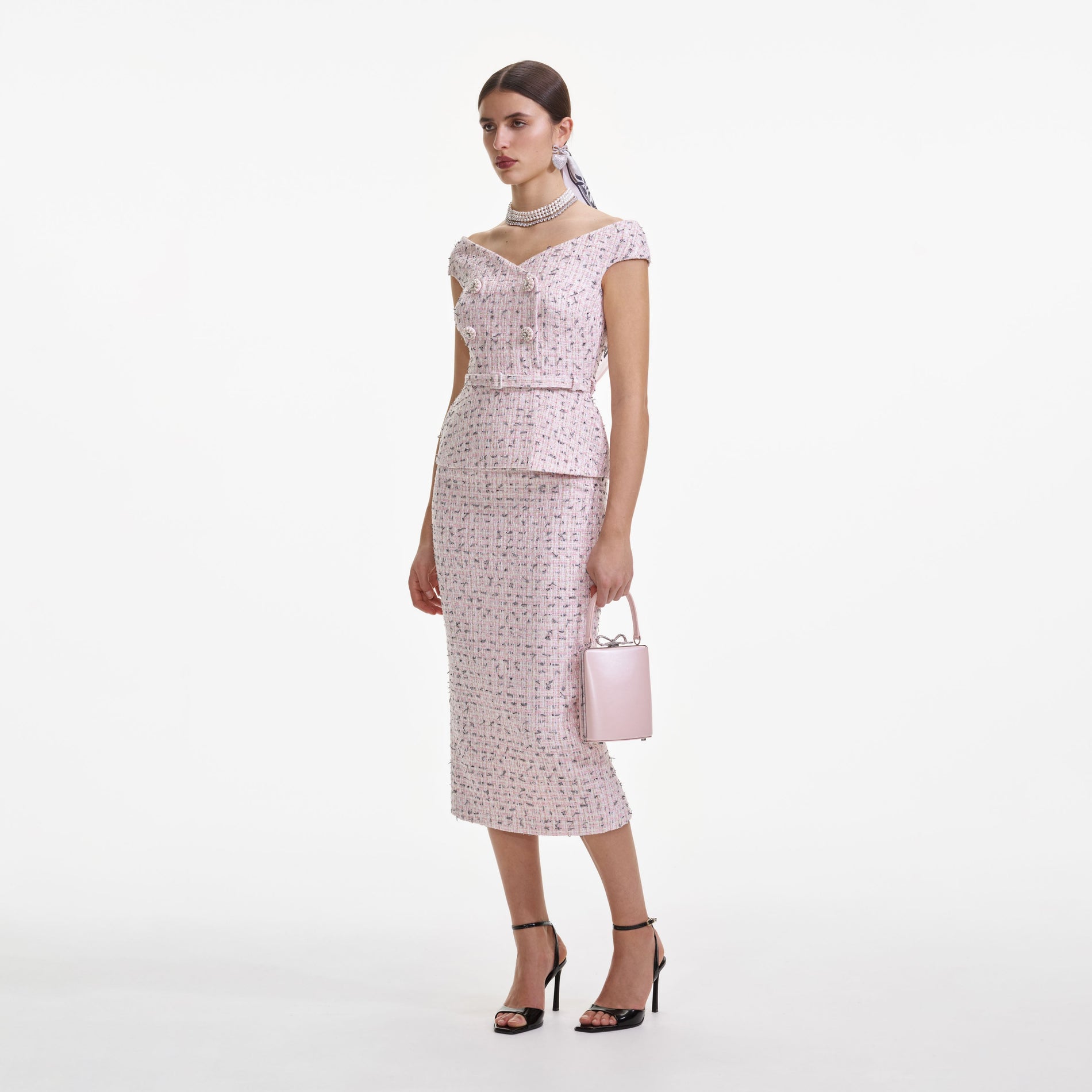 Side view of a woman wearing the Pink Boucle Pearl Midi Dress