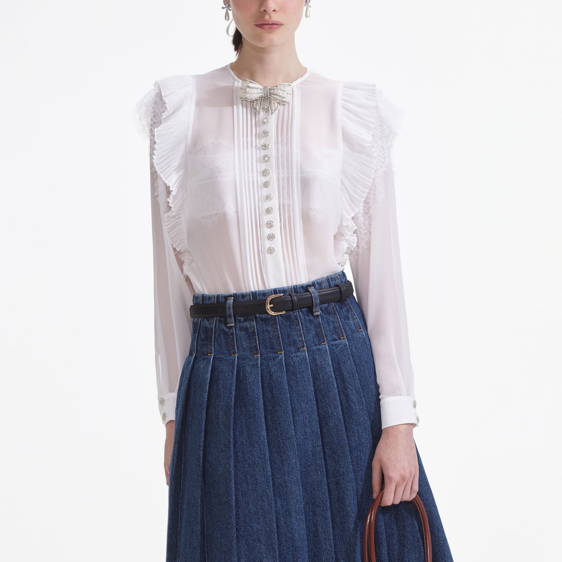 A close up of a woman wearing the White Chiffon Ruffle Top