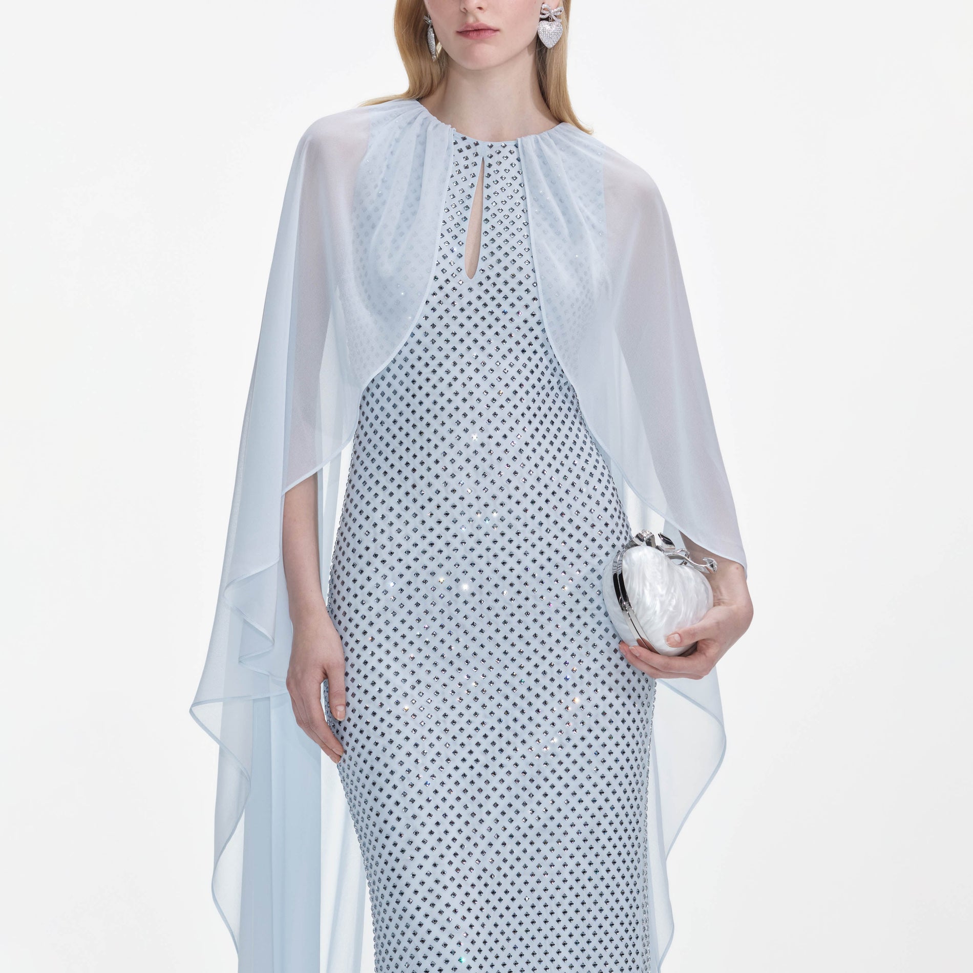 A close up of a woman wearing the Pale Blue Rhinestone Cape Maxi Dress