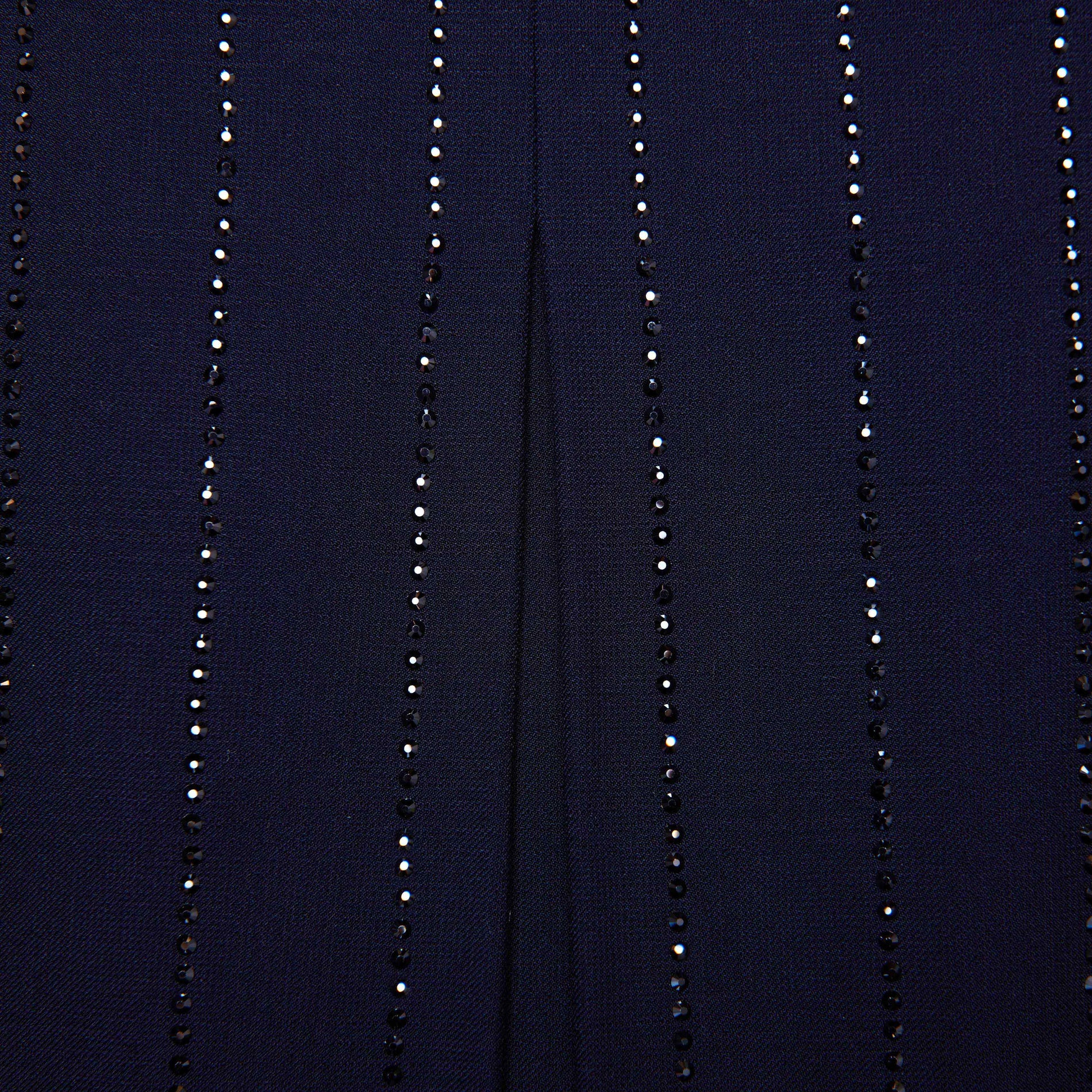Side view of a woman wearing the Navy Rhinestone Pinstripe Mini Skirt