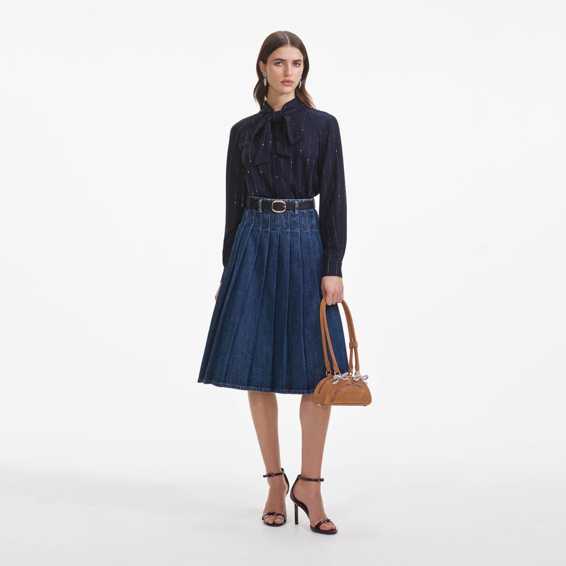 Front view of a woman wearing the Pleated Denim Midi Skirt