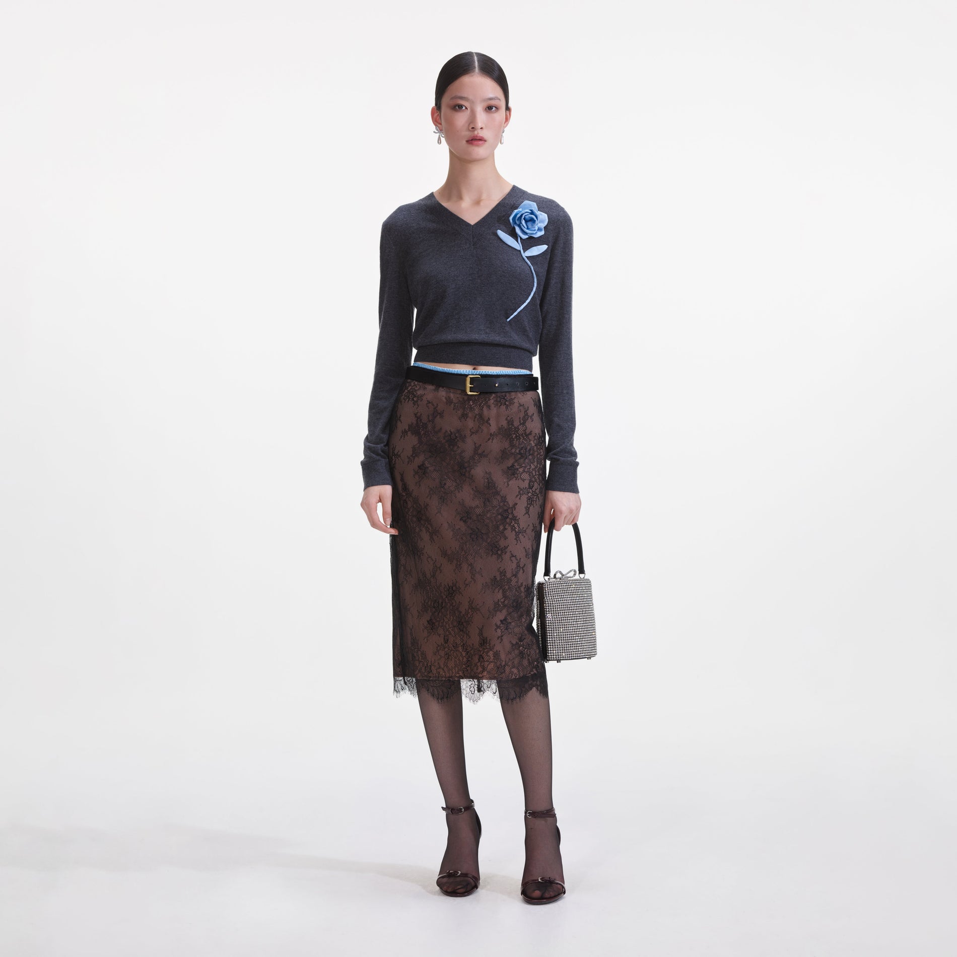 Front view of a woman wearing the Black Lace Midi Skirt