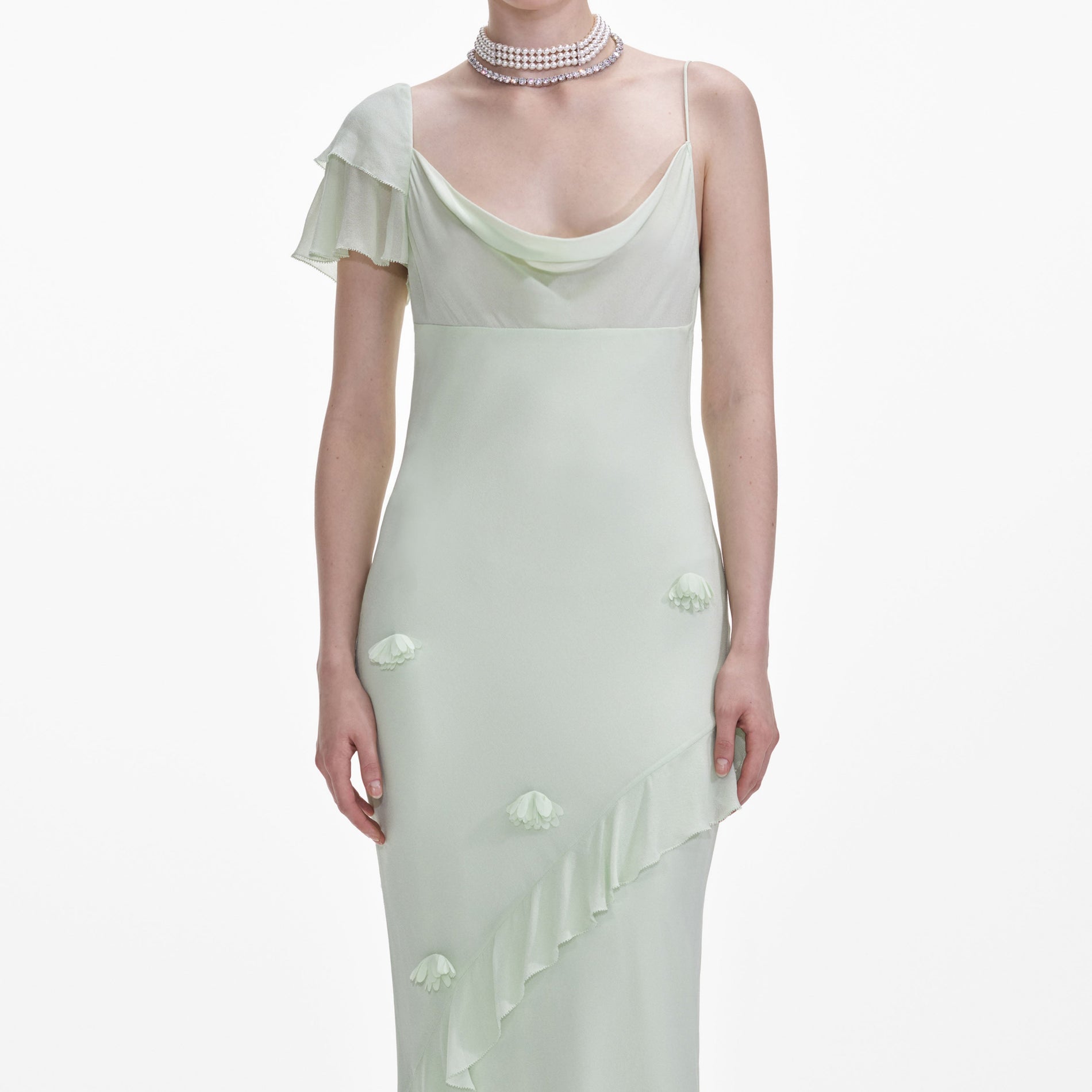 A close up of a woman wearing the Mint Georgette Flower Maxi Dress