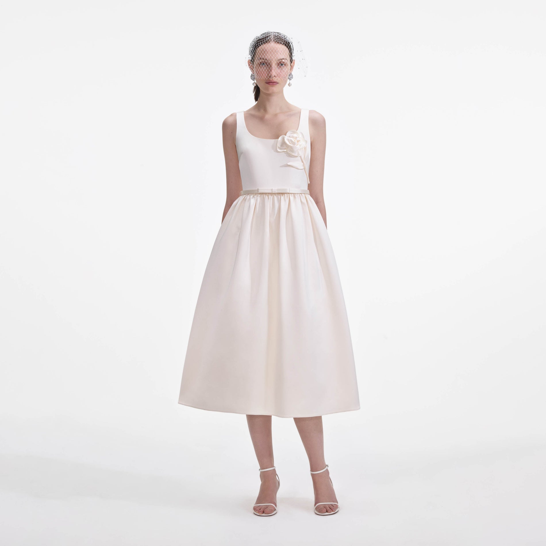 Front view of a woman wearing the Cream Satin Flower Midi Dress