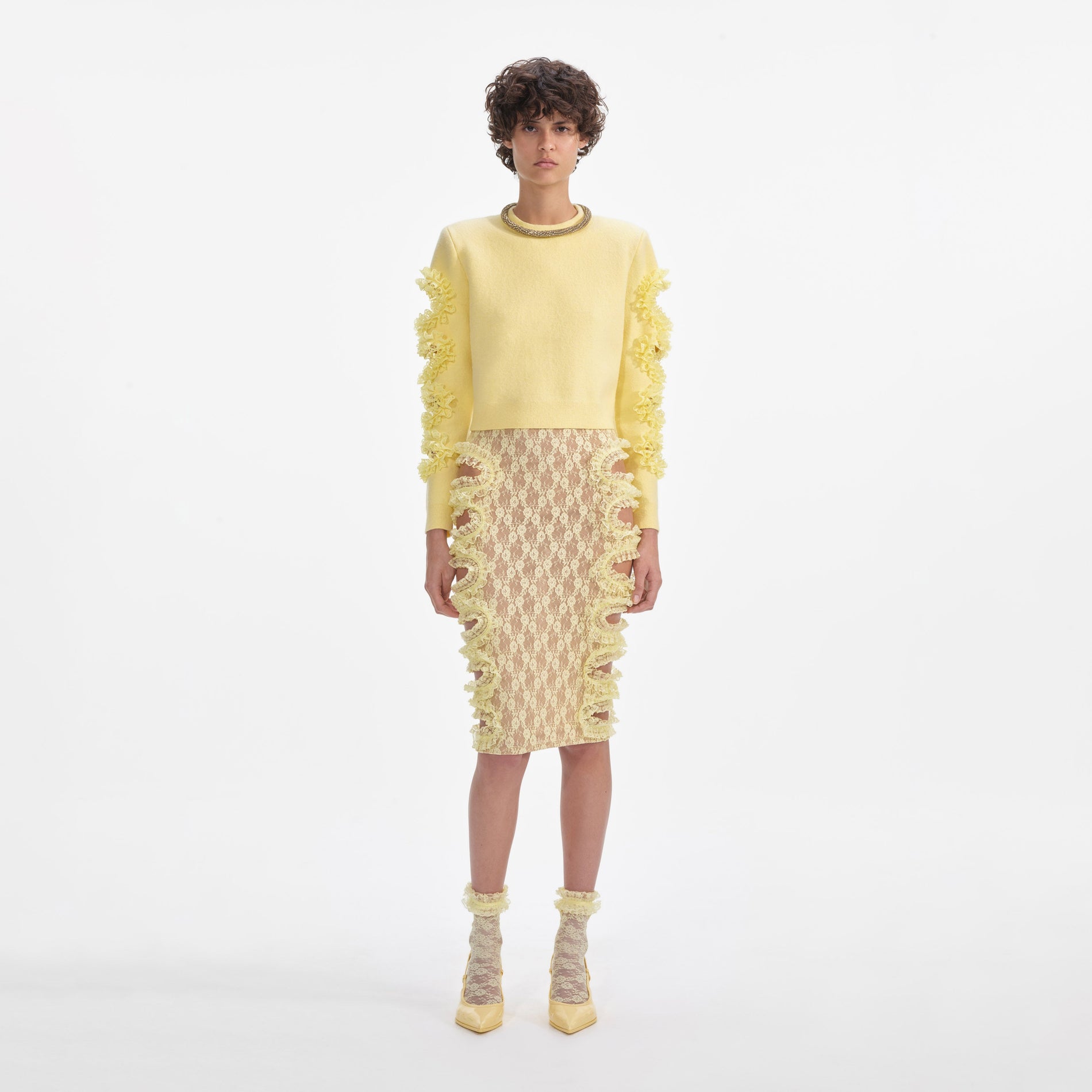 Front view of a woman wearing the Yellow Lace Cut Out Midi Skirt