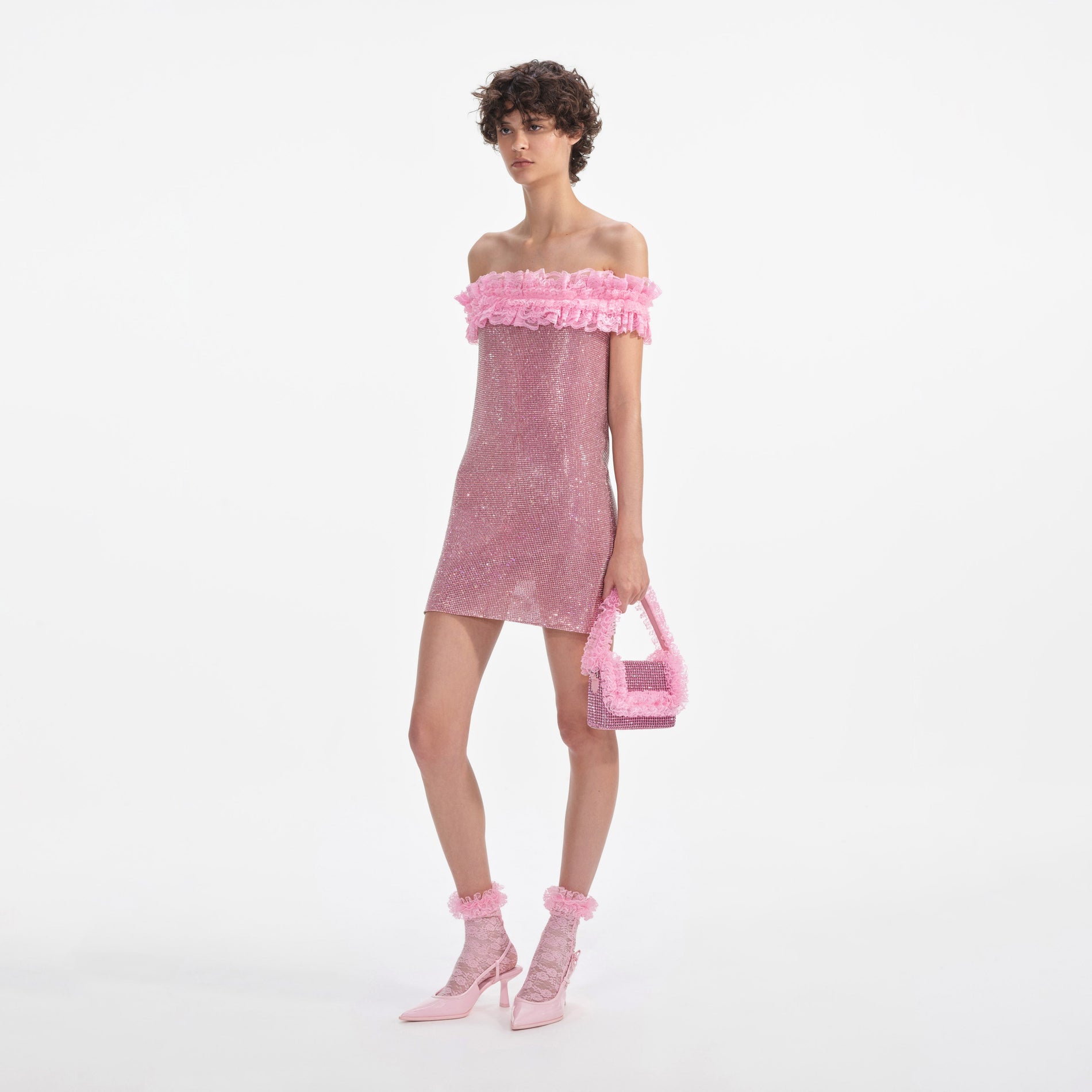 Side view of a woman wearing the Pink Crystal Chainmail Mini Dress