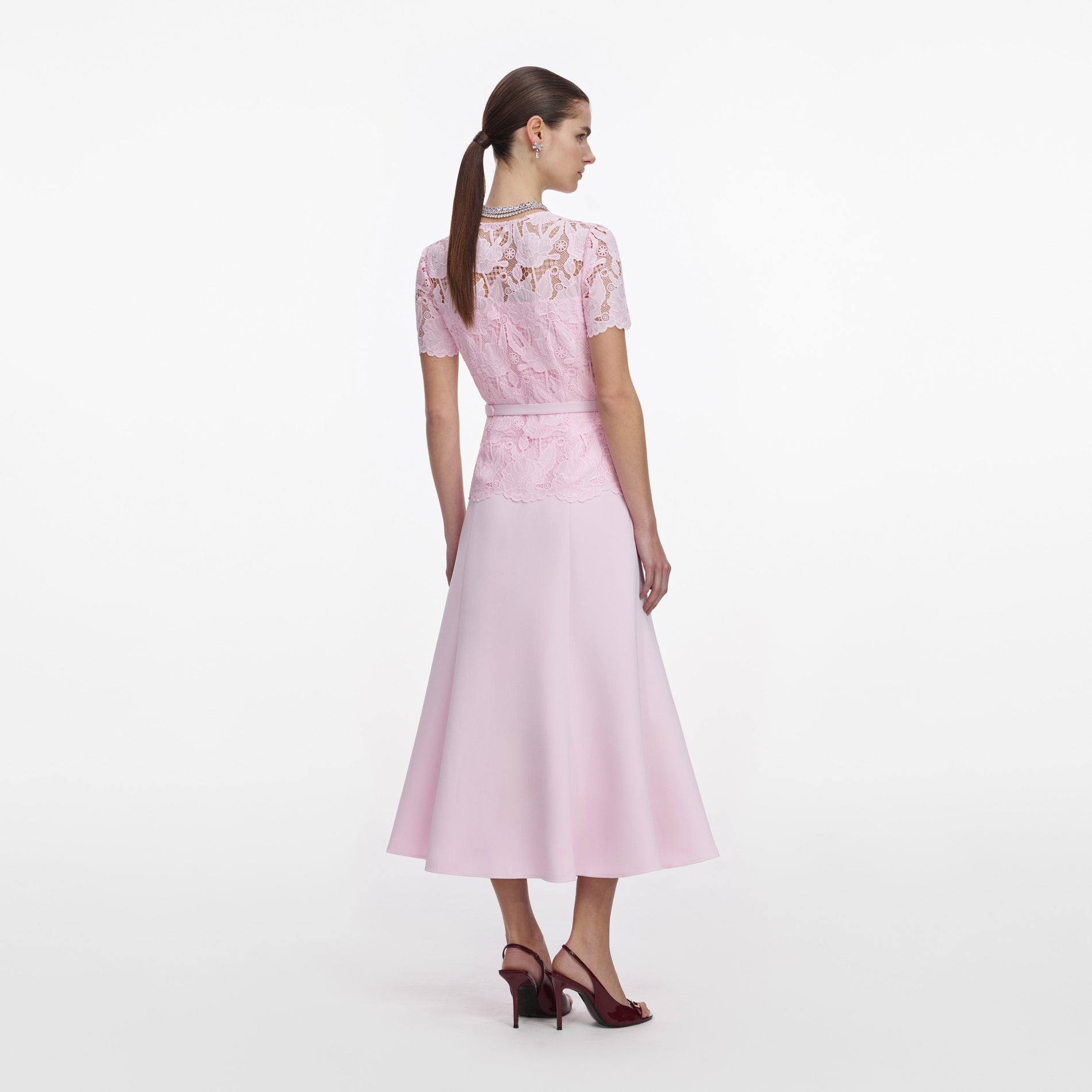 Back view of a woman wearing the Pink Lace Crepe Midi Dress