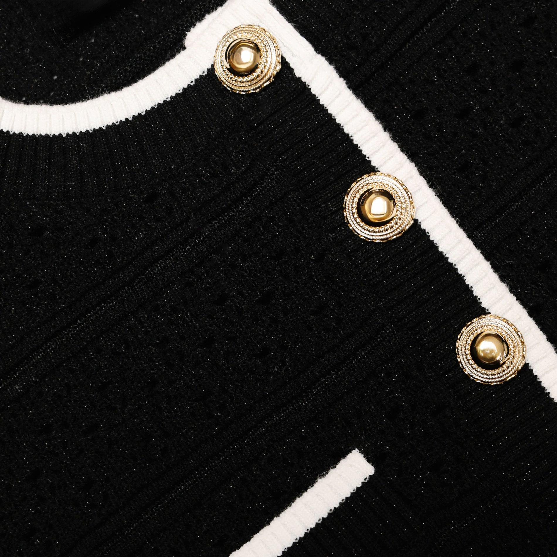 Side view of a woman wearing the Black Pointelle Knit Top