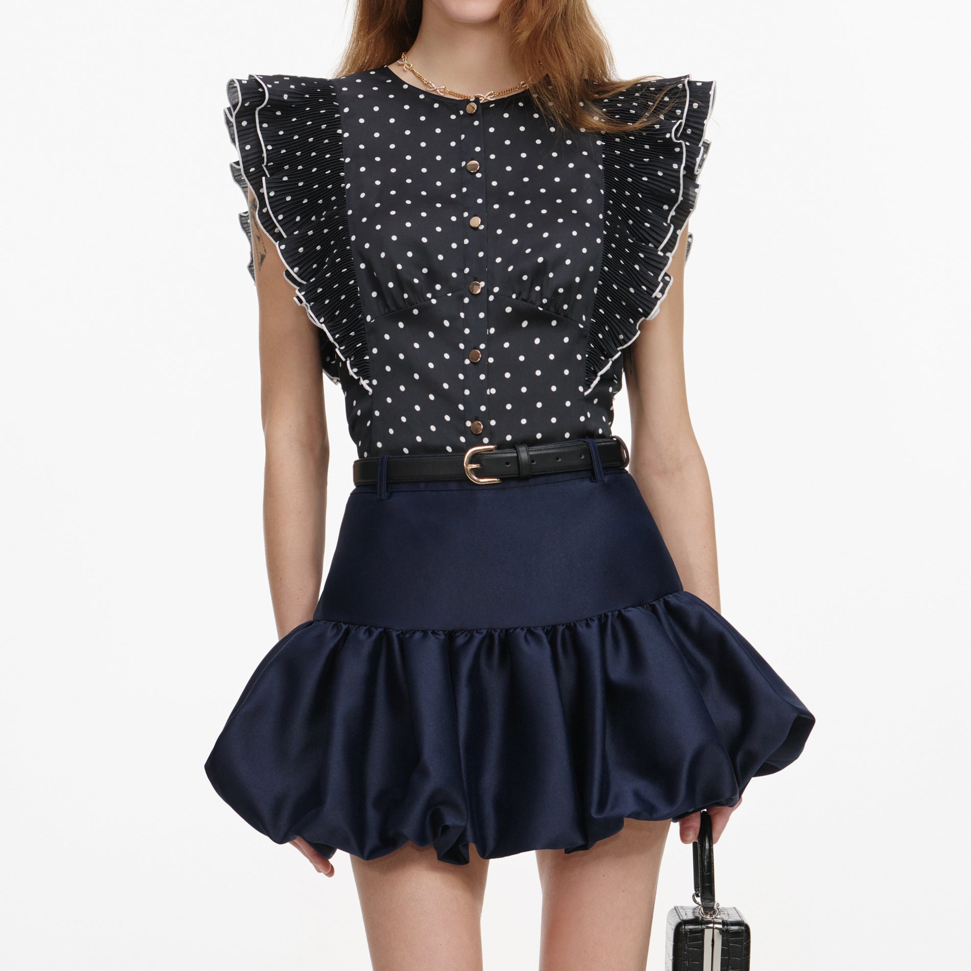 A close up of a woman wearing the Navy Taffeta Skirt