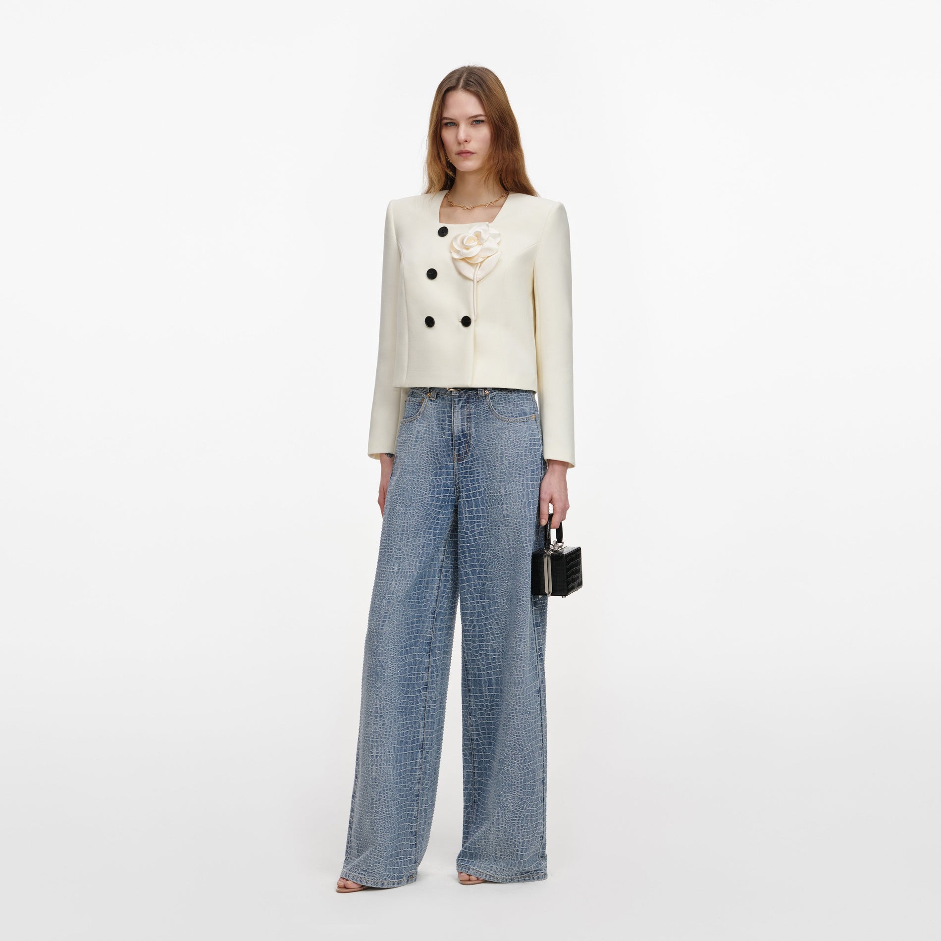 Side view of a woman wearing the Cream 3D Flower Jacket