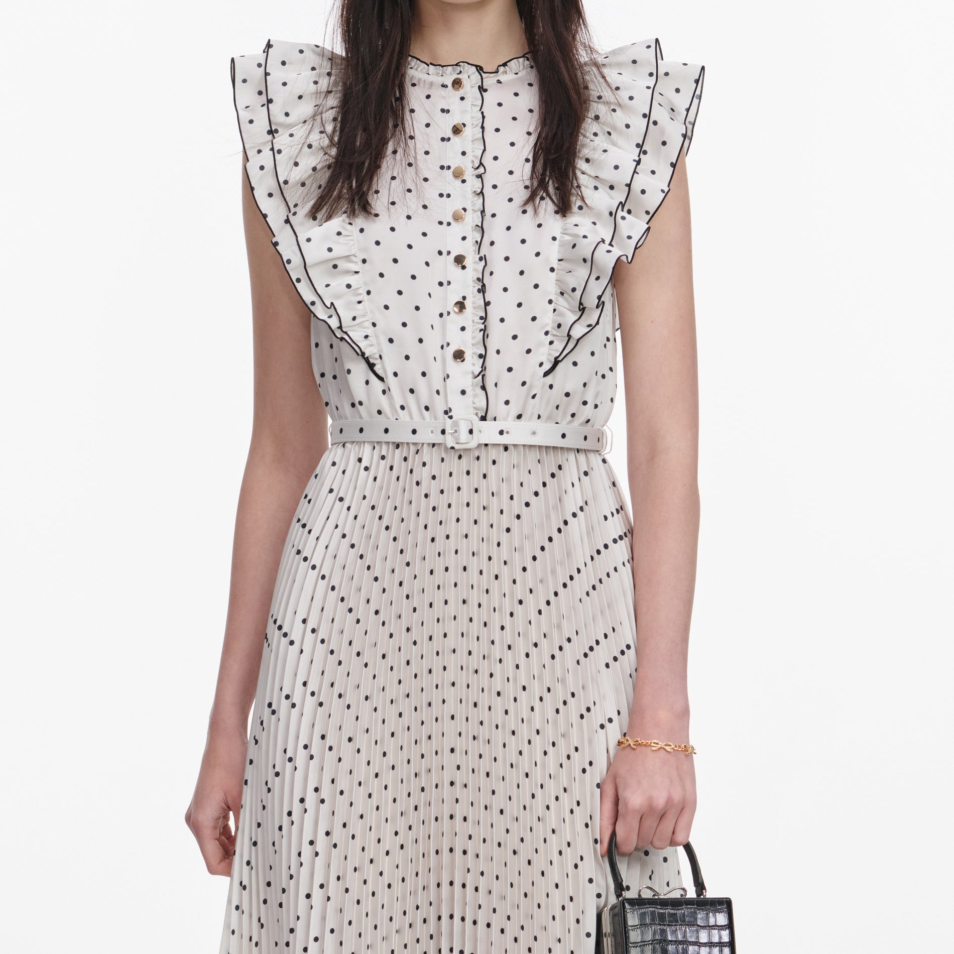 A close up of a woman wearing the Cream Ramie Polka Dot Midi Dress