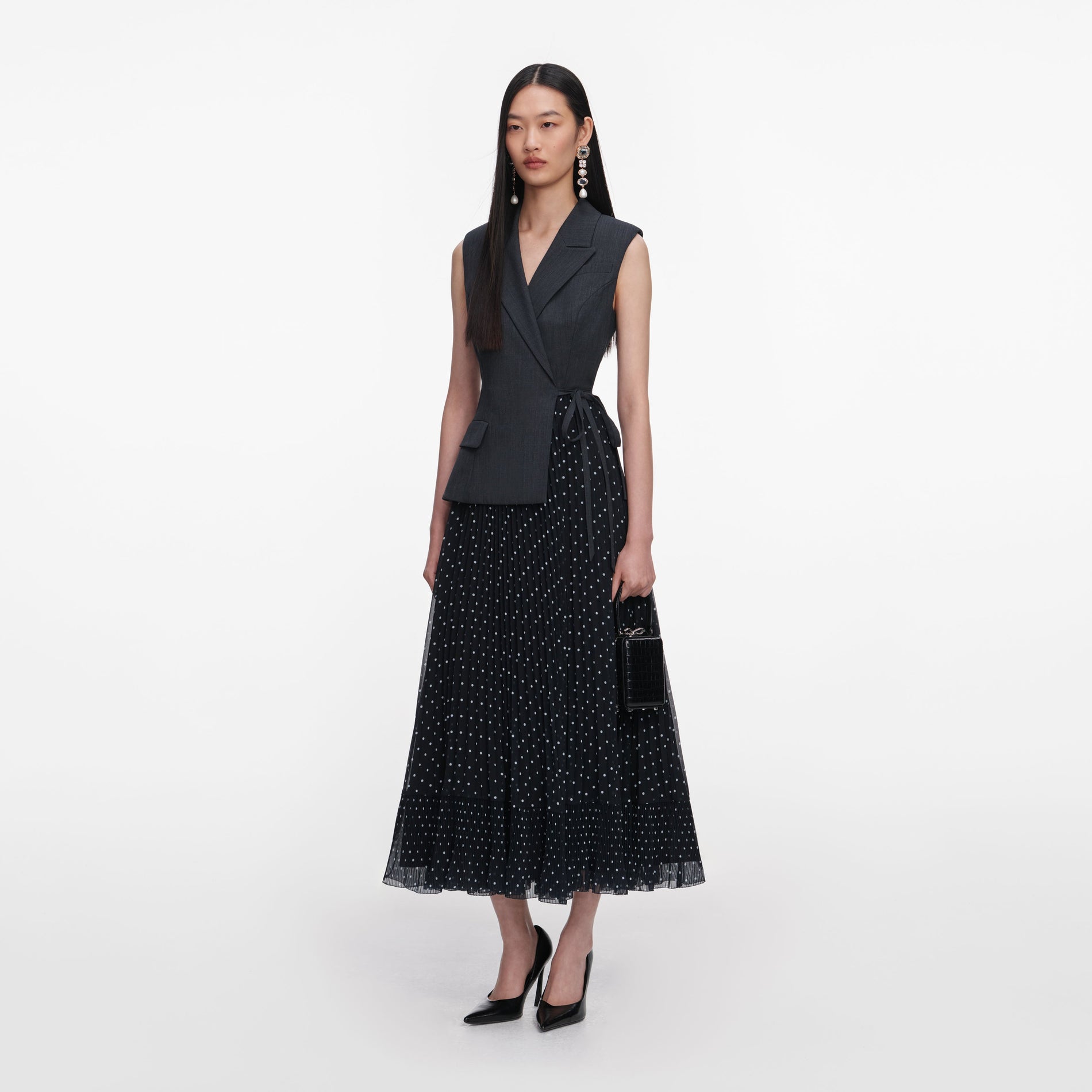 Side view of a woman wearing the Grey Tailored Polka Dot Midi Dress