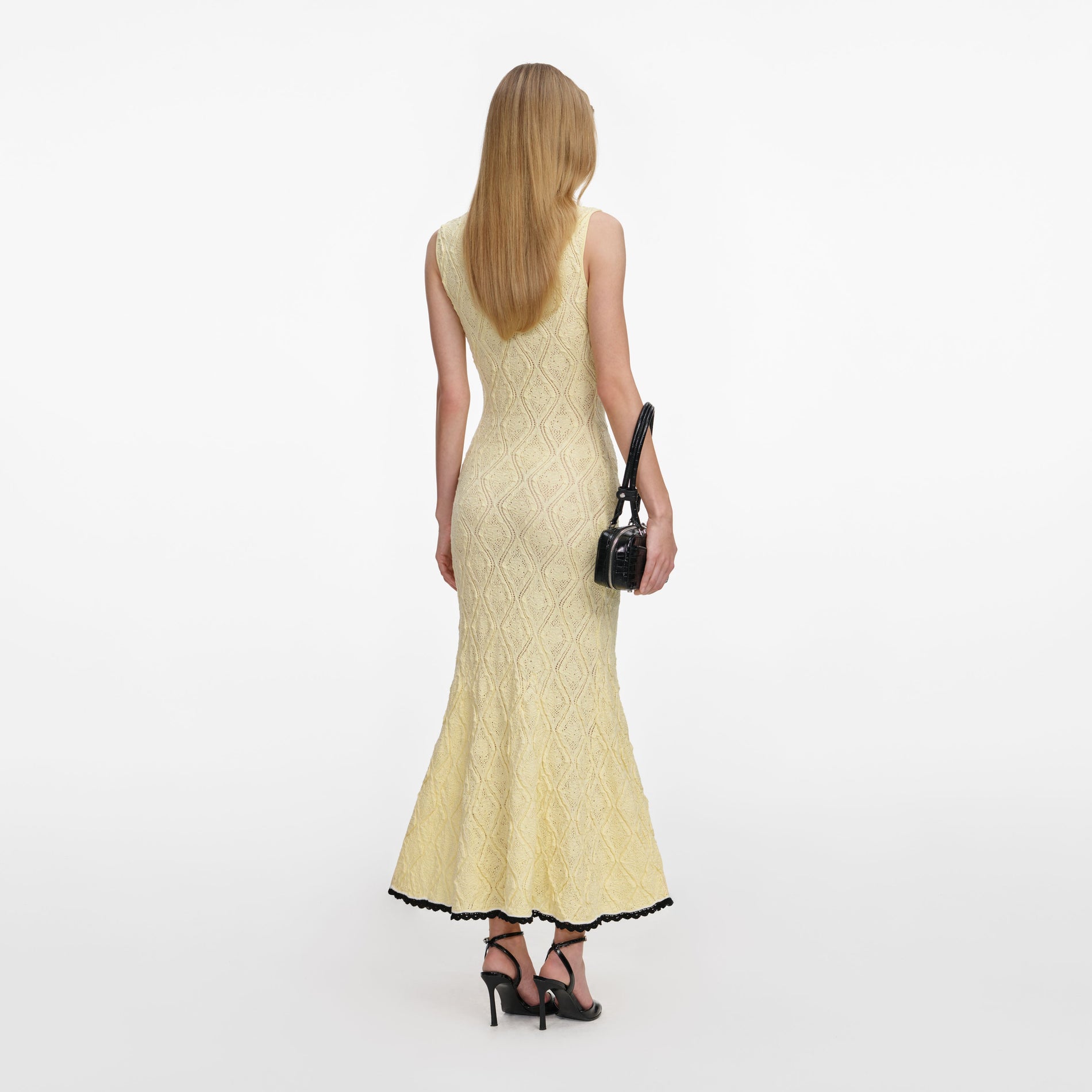 Back view of a woman wearing the Yellow Pointelle Knit Midi Dress