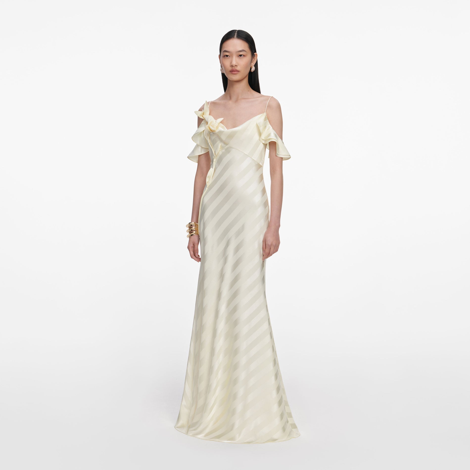 Side view of a woman wearing the Yellow Satin Striped Maxi Dress