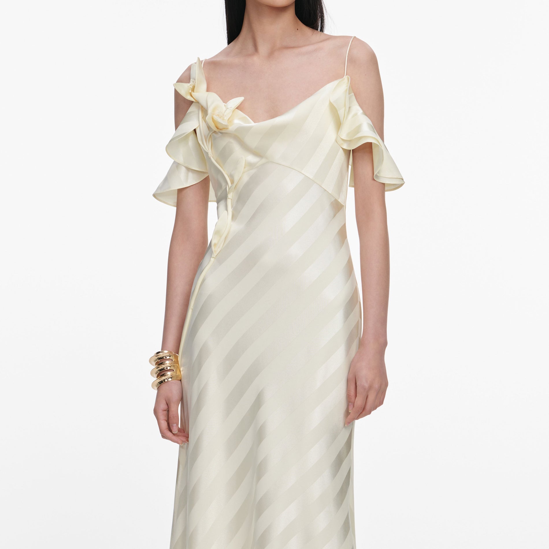 A close up of a woman wearing the Yellow Satin Striped Maxi Dress