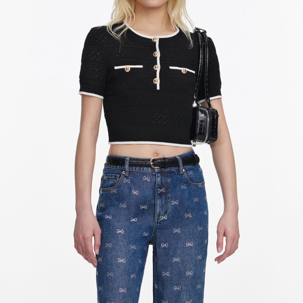 A close up of a woman wearing the Lightweight Bow Embellished Jeans