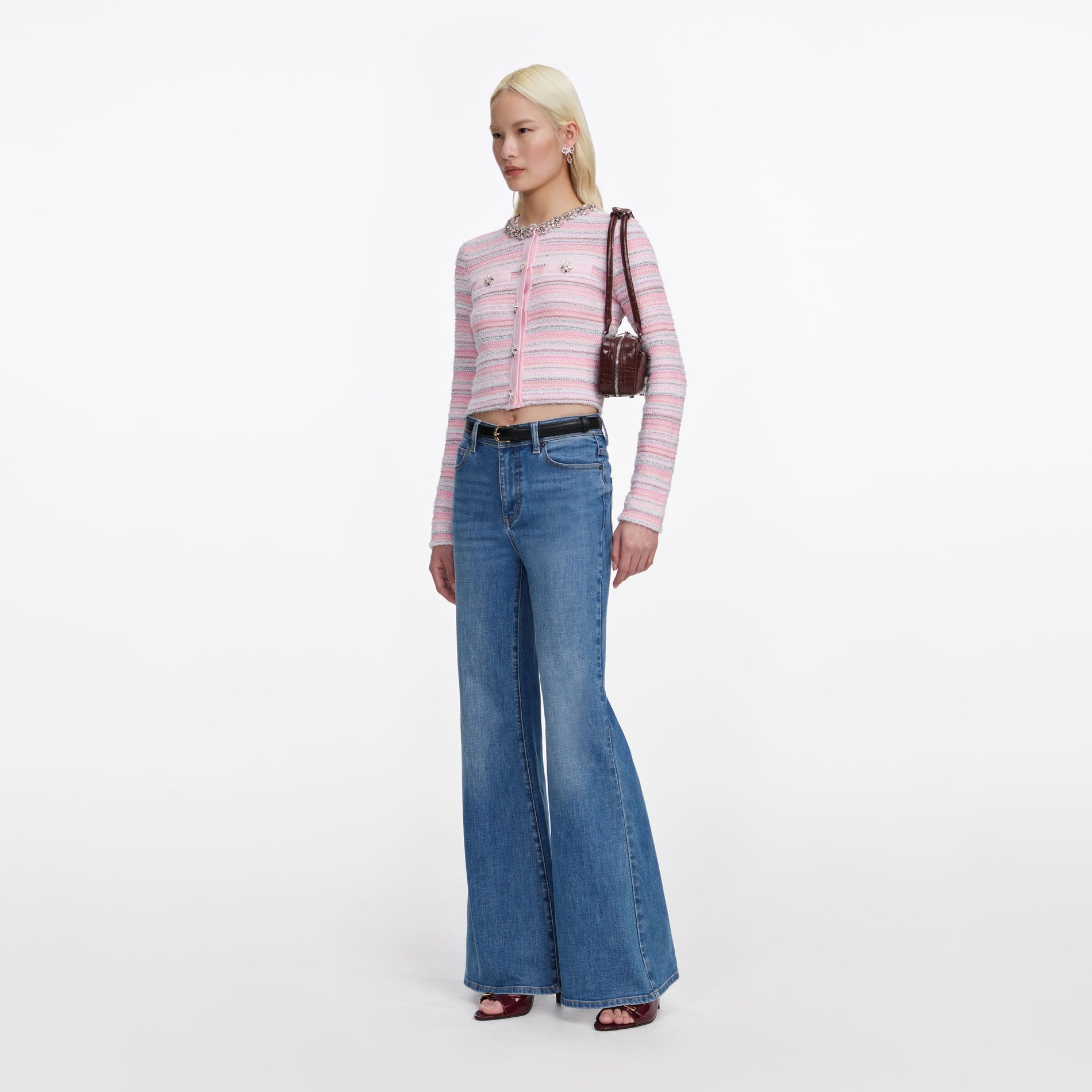 Side view of a woman wearing the Mid Blue Flared Jeans