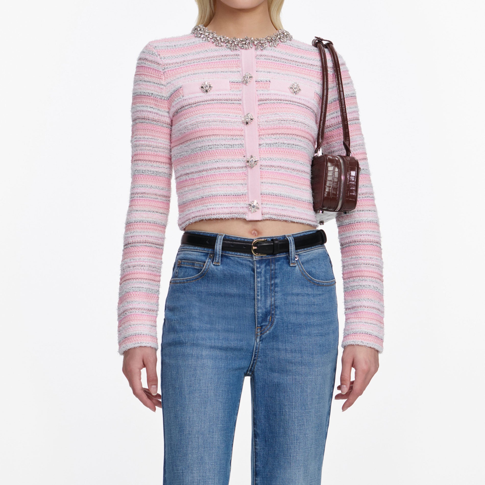 A close up of a woman wearing the Mid Blue Flared Jeans